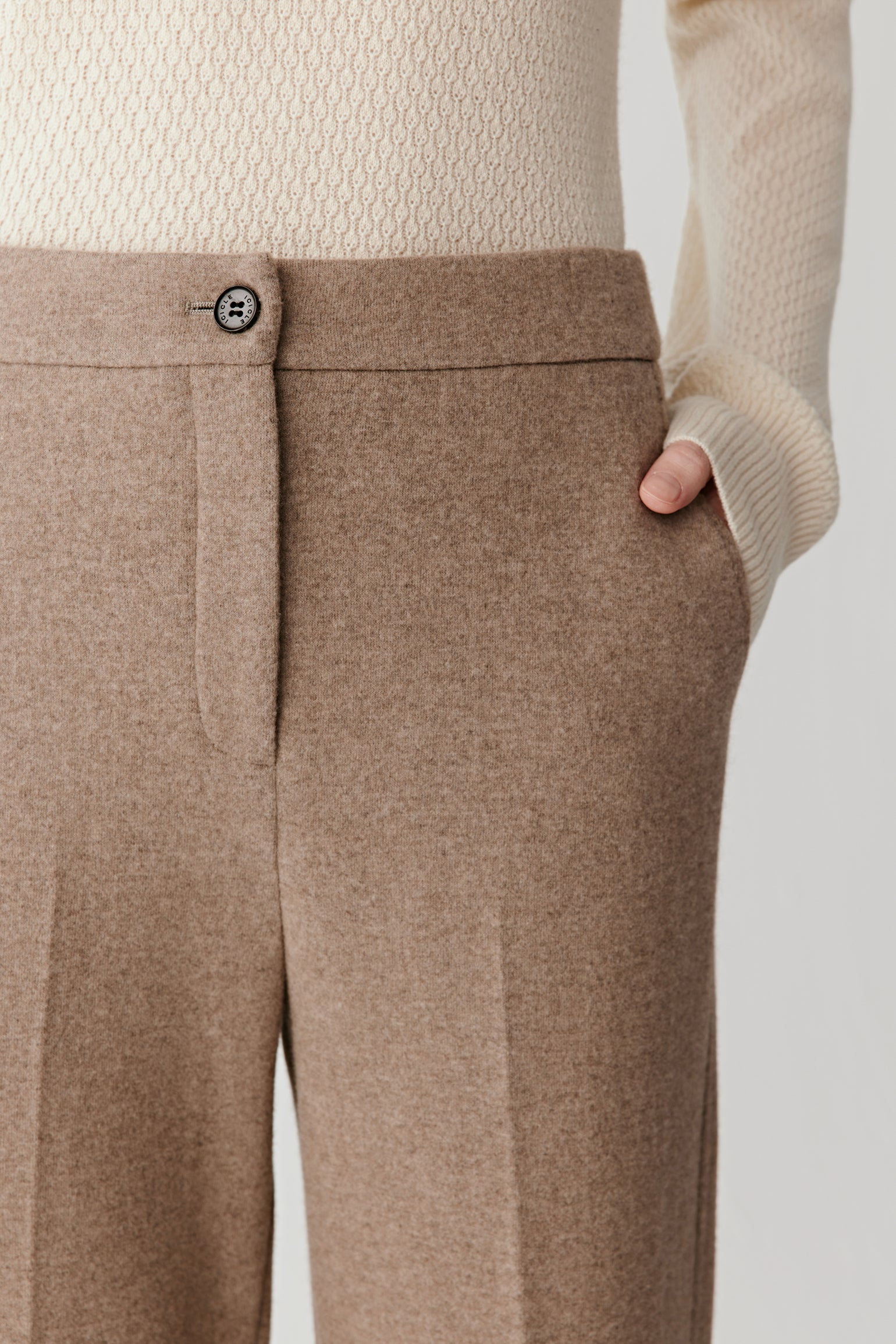 Close-up of the side pocket and fabric texture of the double-faced jersey trousers.