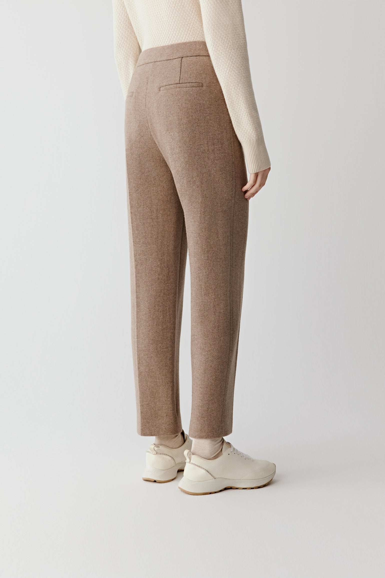 Back view of the double-faced wool and cashmere jersey trousers, highlighting the clean back silhouette.