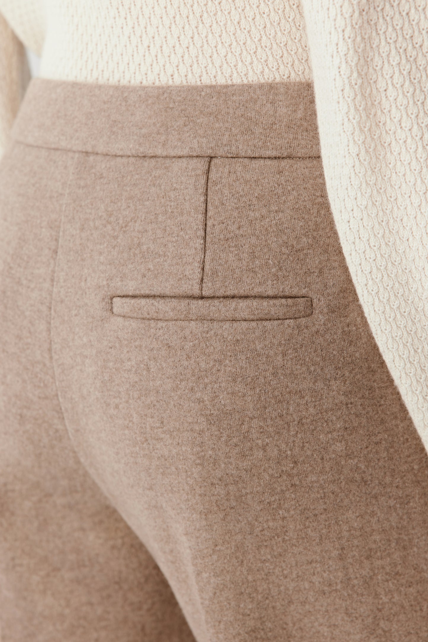 Detail close-up of the double-faced wool and cashmere jersey fabric, showing its dense, refined structure.