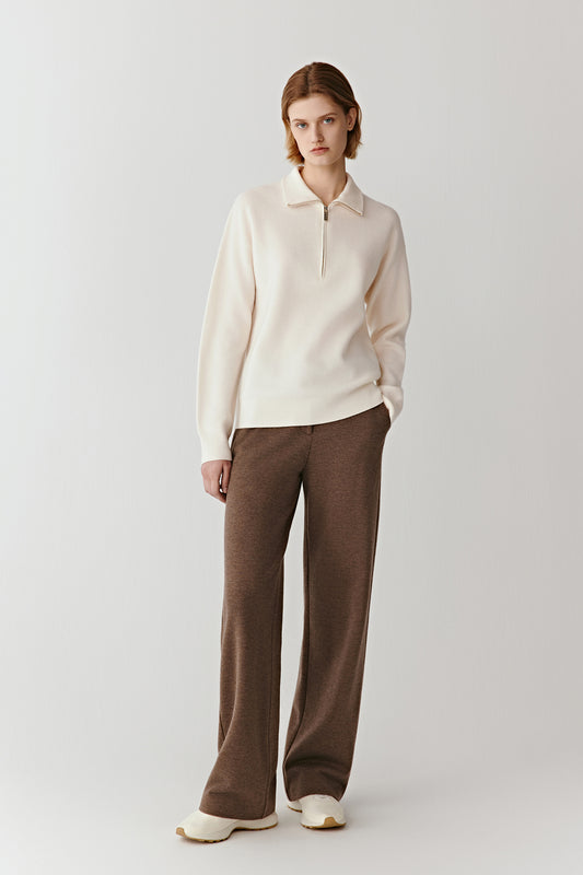 Full-length front view of a cream worsted wool pullover with a zipped stand collar and clean, minimalist lines.