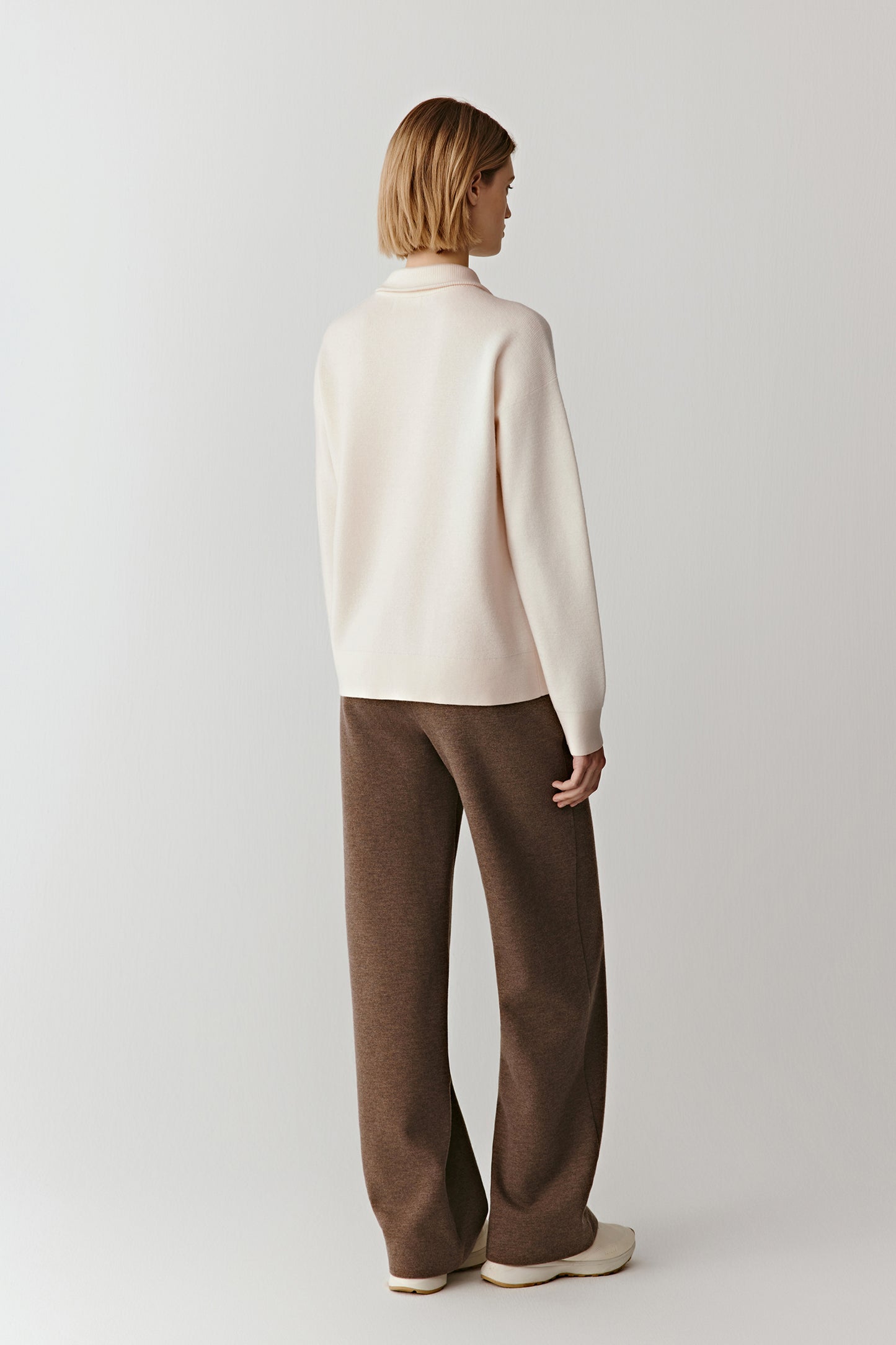 Full-length back view of the worsted wool pullover, showing a straight silhouette and smooth knit texture.