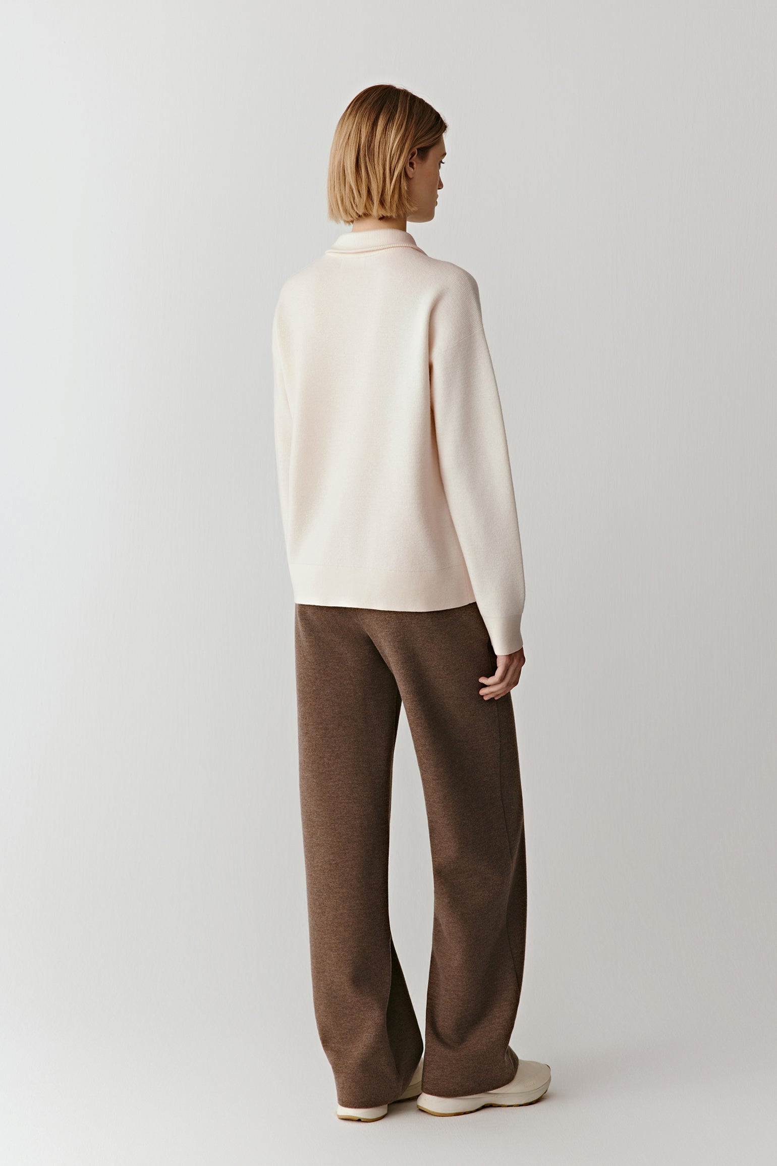 Full-length back view of the worsted wool pullover, showing a straight silhouette and smooth knit texture.