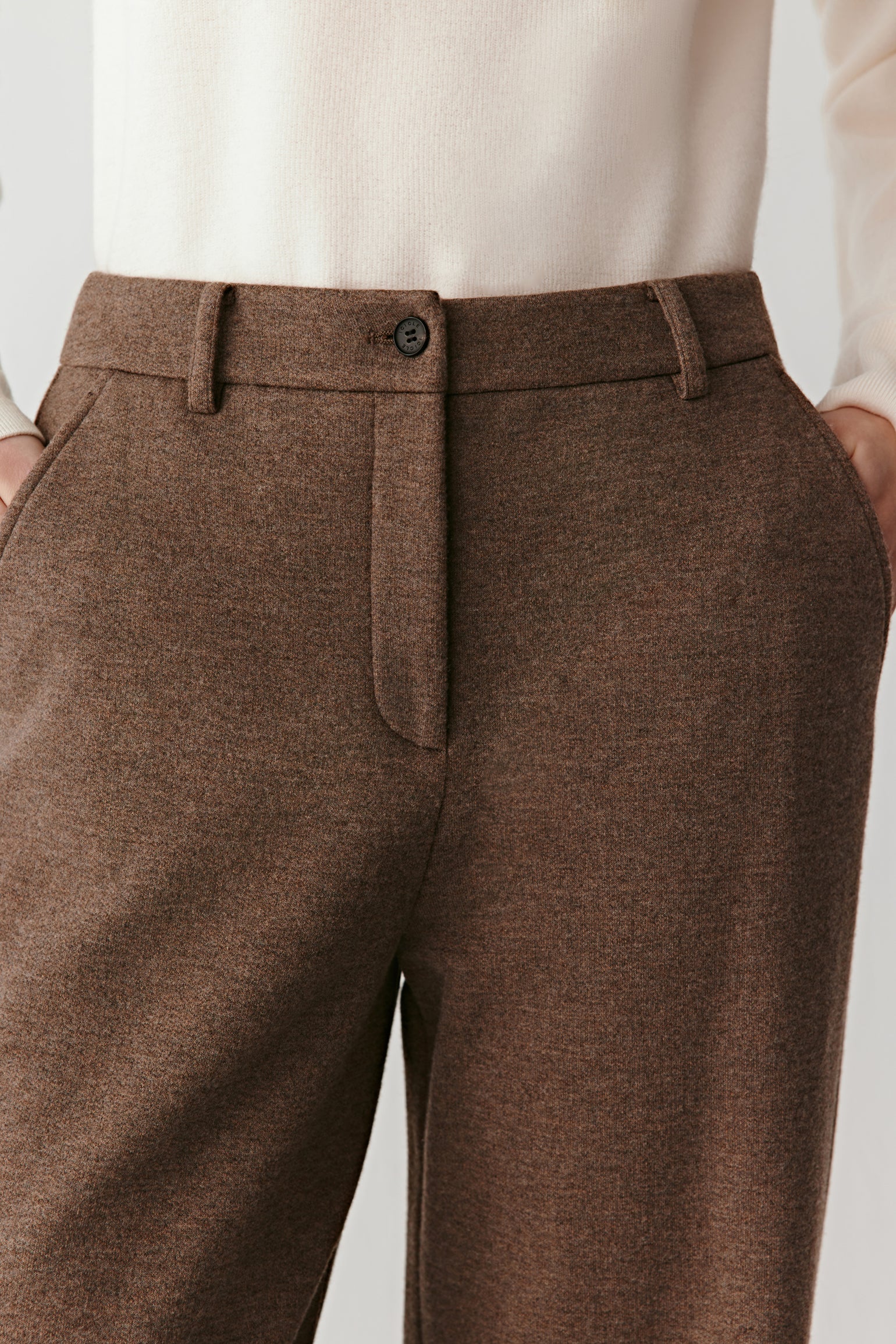 Close-up of the side pocket and brushed jersey texture of the trousers.
