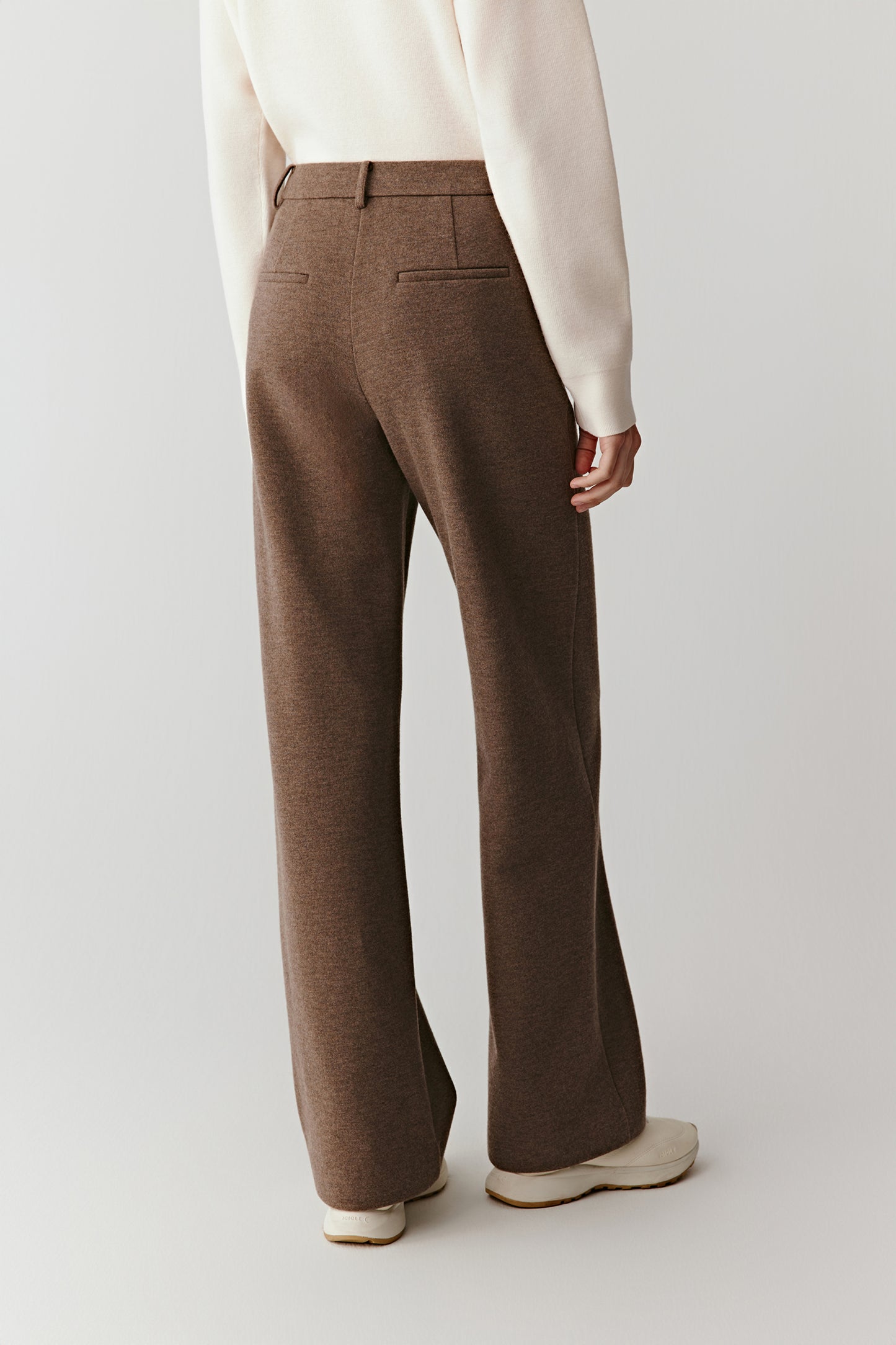 Full-length back view of the straight-leg jersey trousers, highlighting a clean waistband and smooth back line.