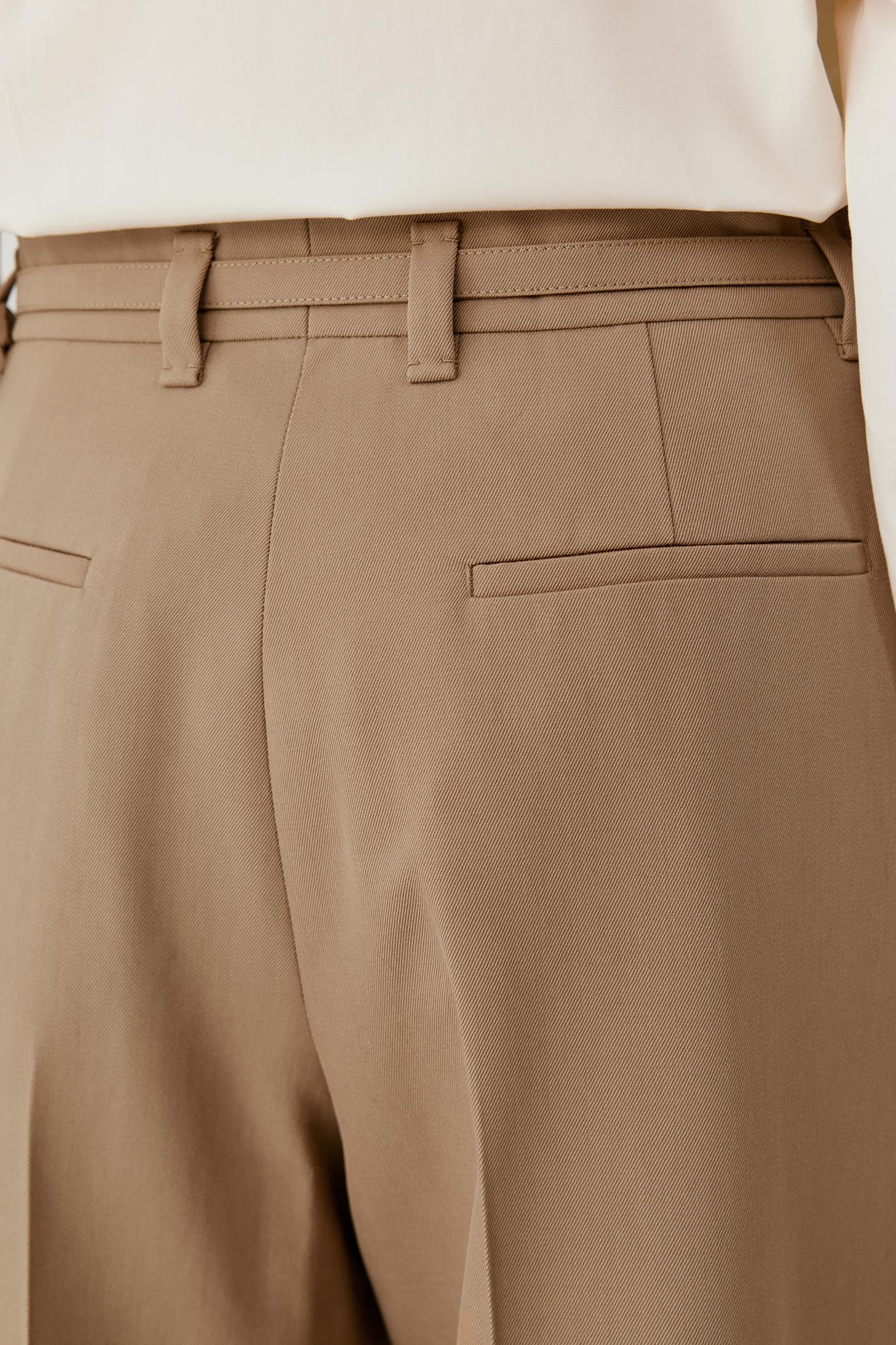 Close-up of the back waistband and welt pocket, highlighting the clean construction and camel wool twill fabric.