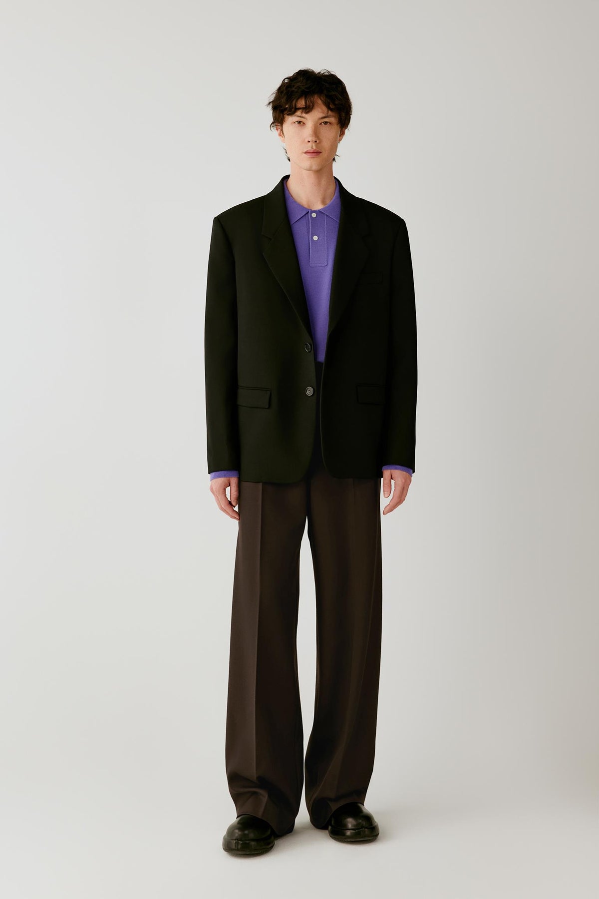 Full-length front view highlighting the straight cut, notched lapels and clean tailored construction.