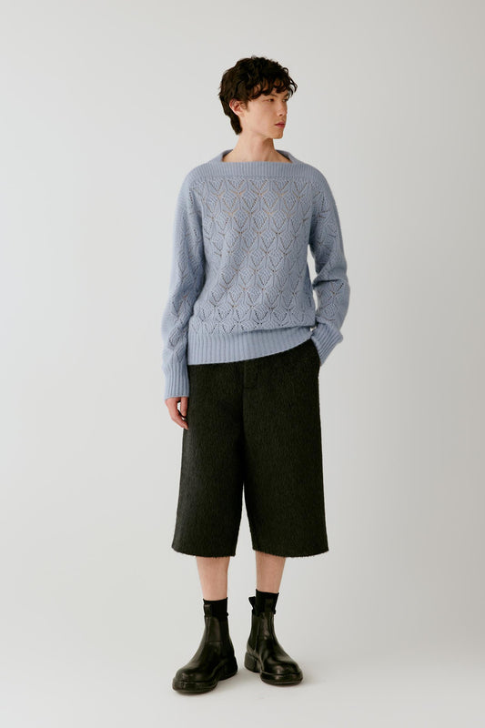 Front view of a man wearing anthracite melange camel and mohair shorts, showing the high-rise waist, wide below-the-knee cut and textured surface.