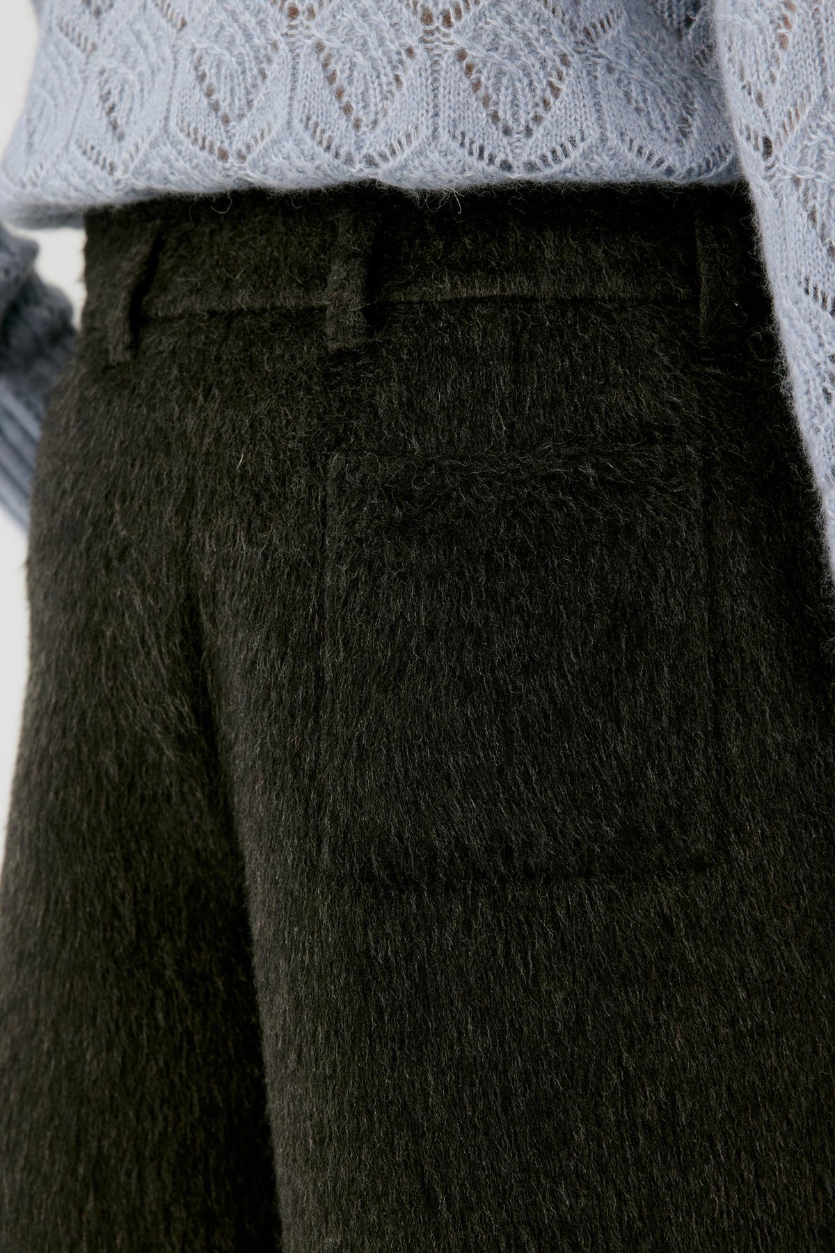 Close-up of the back highlighting the rear welt pockets and anthracite melange textured surface.