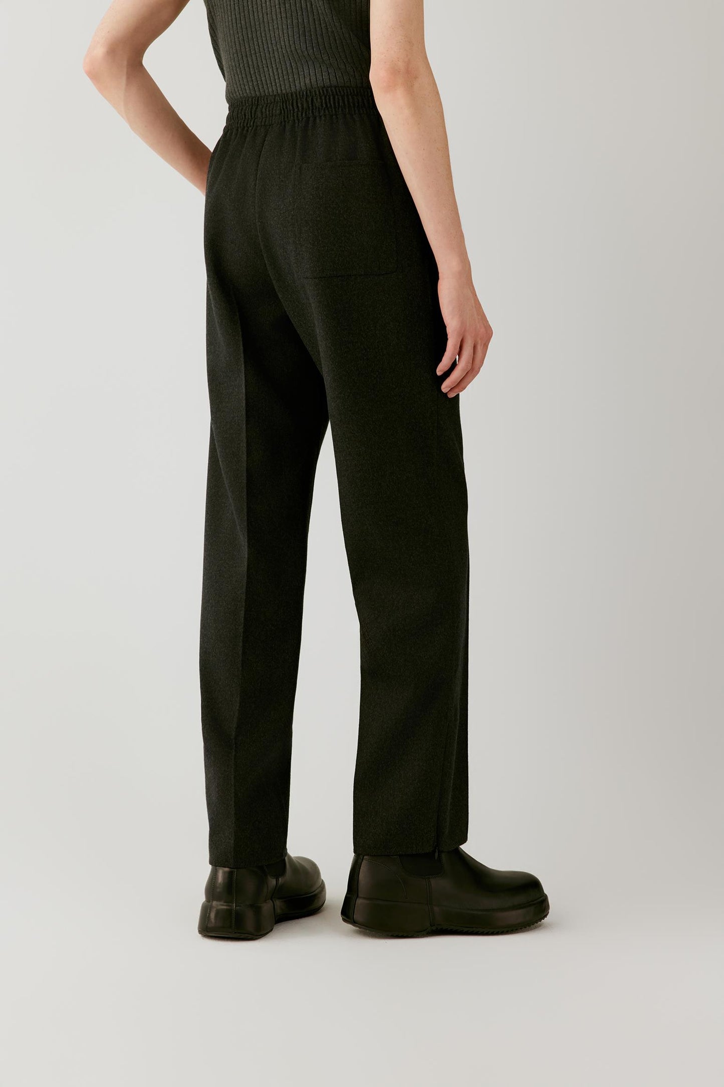Three-quarter view highlighting the straight-leg silhouette and fluid fall of the double-face wool.
