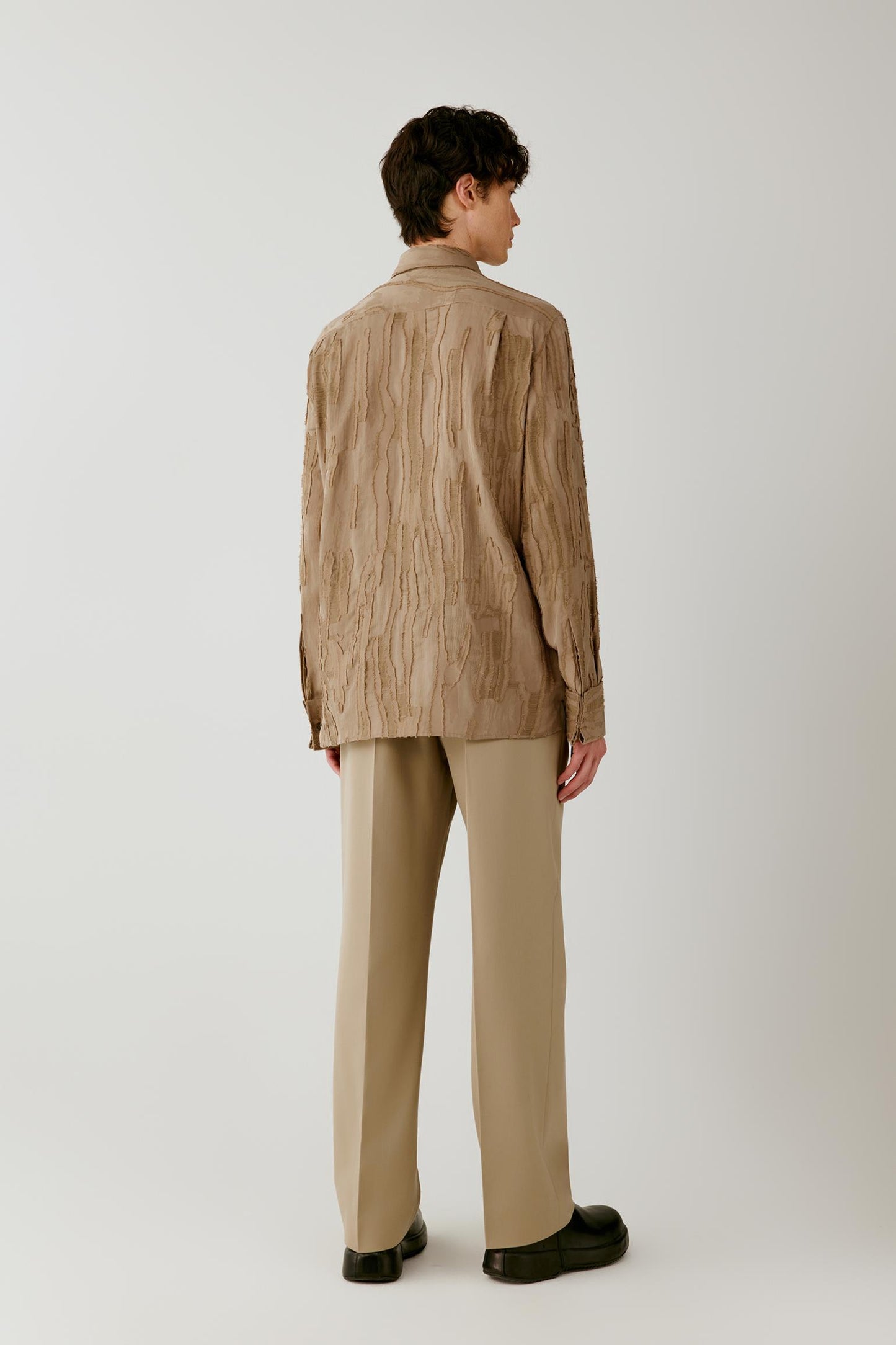 Full-length back view highlighting the clean back construction, straight silhouette and raised jacquard texture.