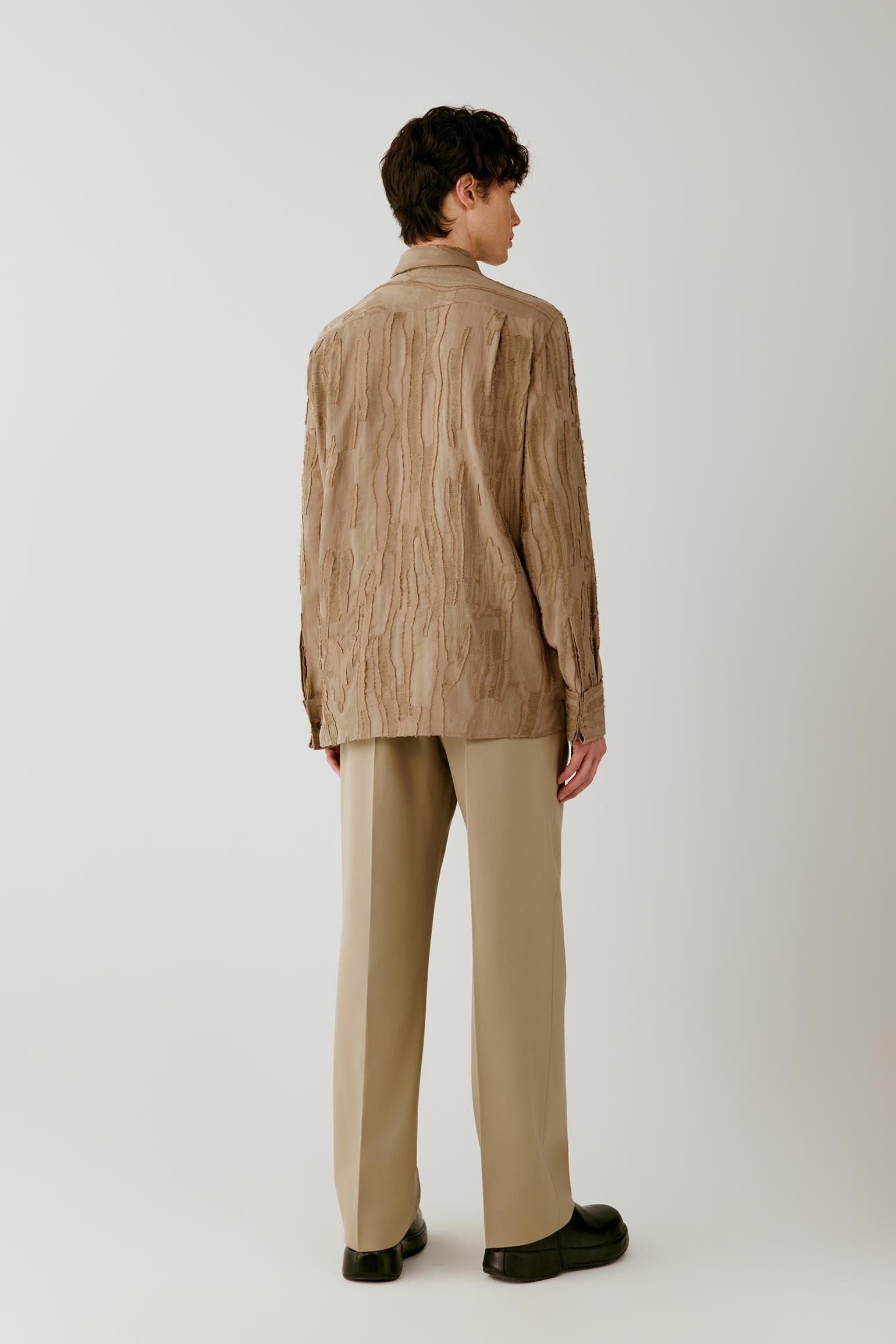 Full-length back view highlighting the clean back construction, straight silhouette and raised jacquard texture.