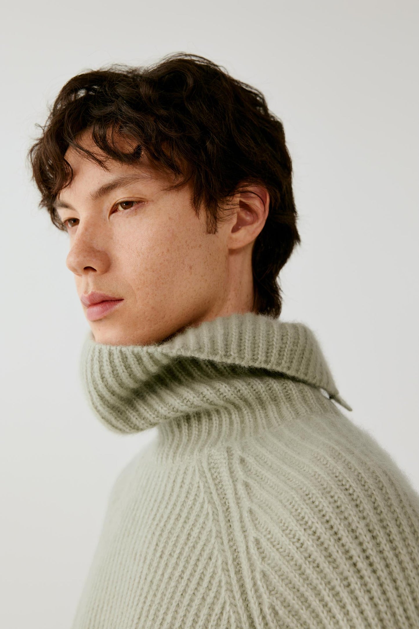 Close-up highlighting the generous folded turtleneck and substantial ribbed knit.