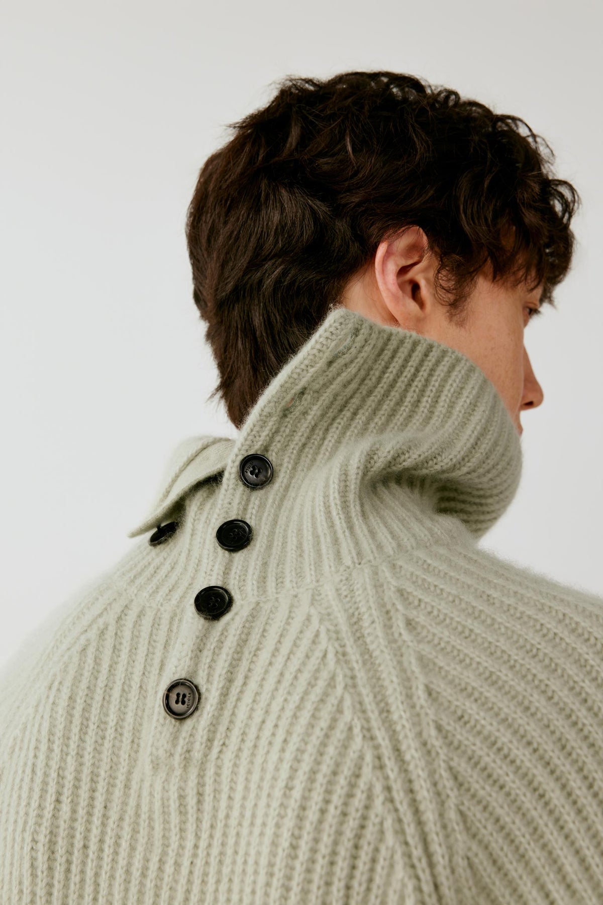 Close-up of the back collar, highlighting the folded turtleneck and ribbed texture.