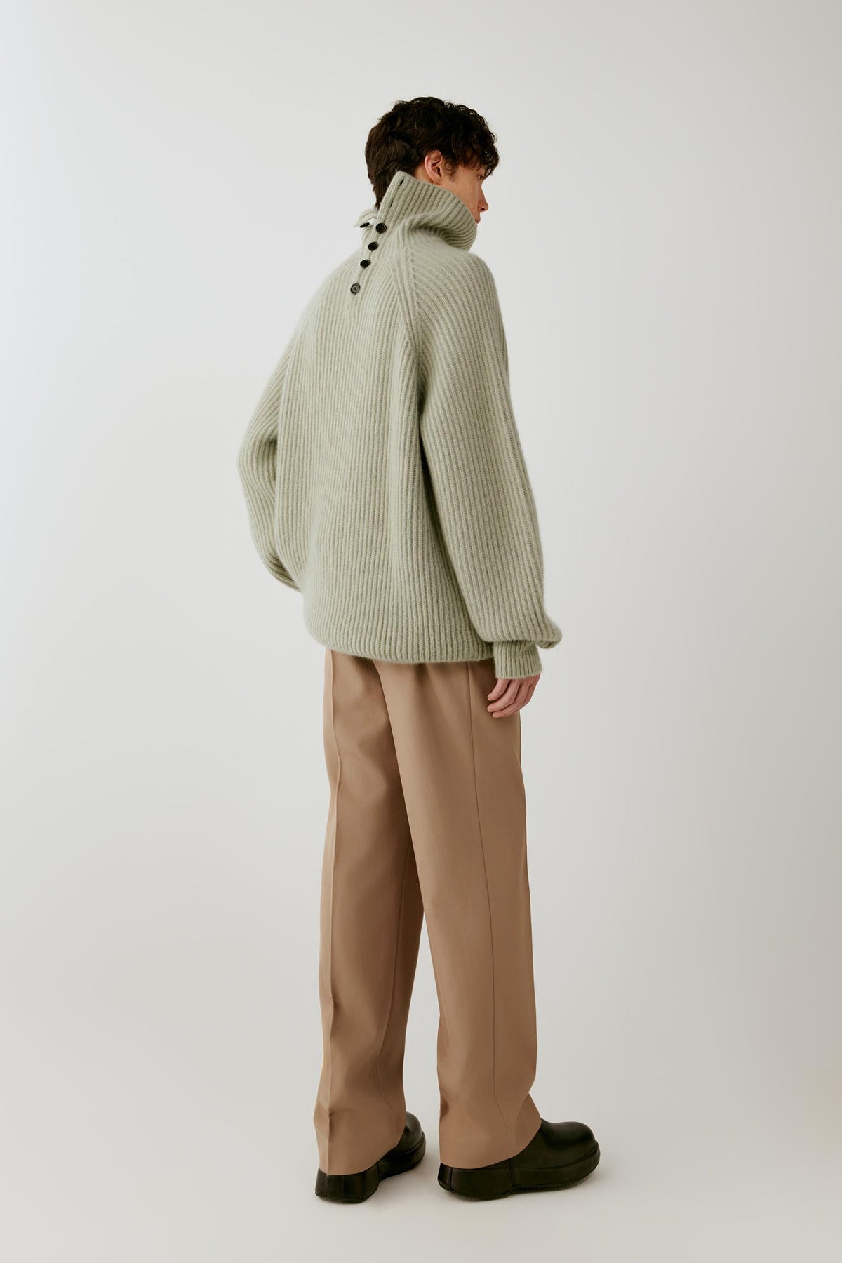 Full-length back view showing the oversized cut, ribbed texture and wide trims.