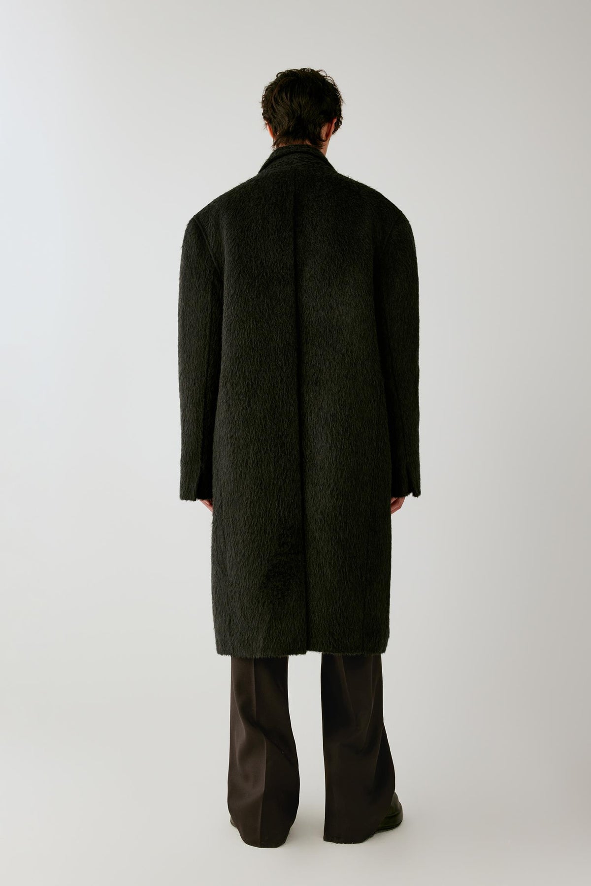 Back view of the charcoal grey camel and mohair coat, showing the long straight silhouette and clean back seam.