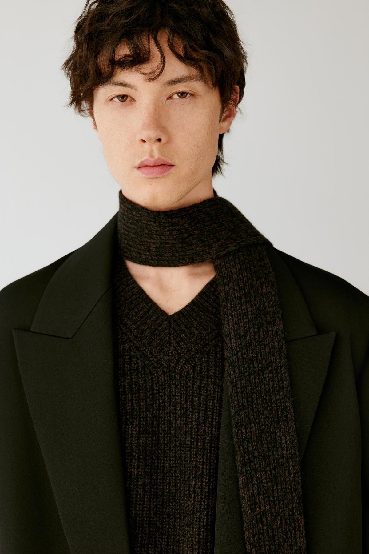 Close-up highlighting the pronounced peak lapels, high neckline and structured double-face wool construction.