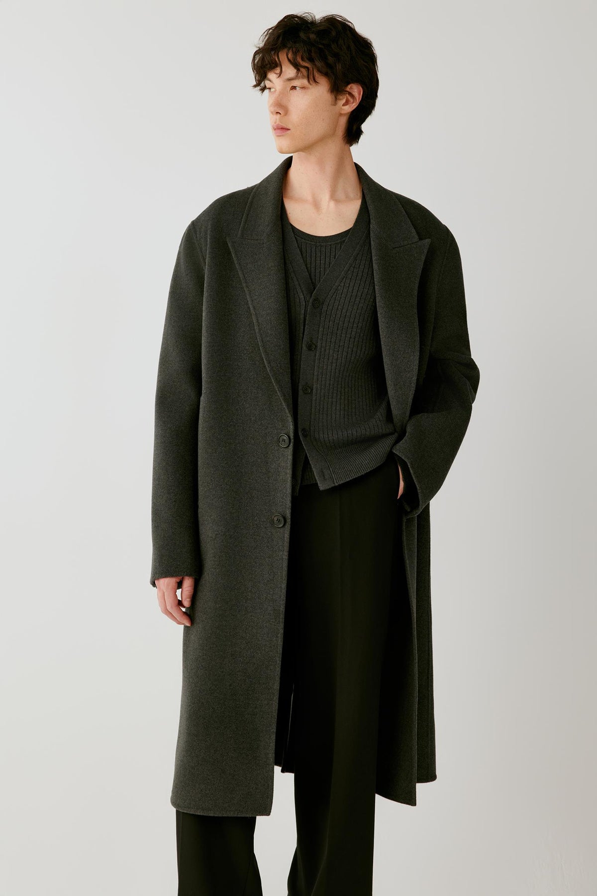 Full-length view highlighting the elongated straight cut and fluid drape of the dark grey melange double-face wool coat.