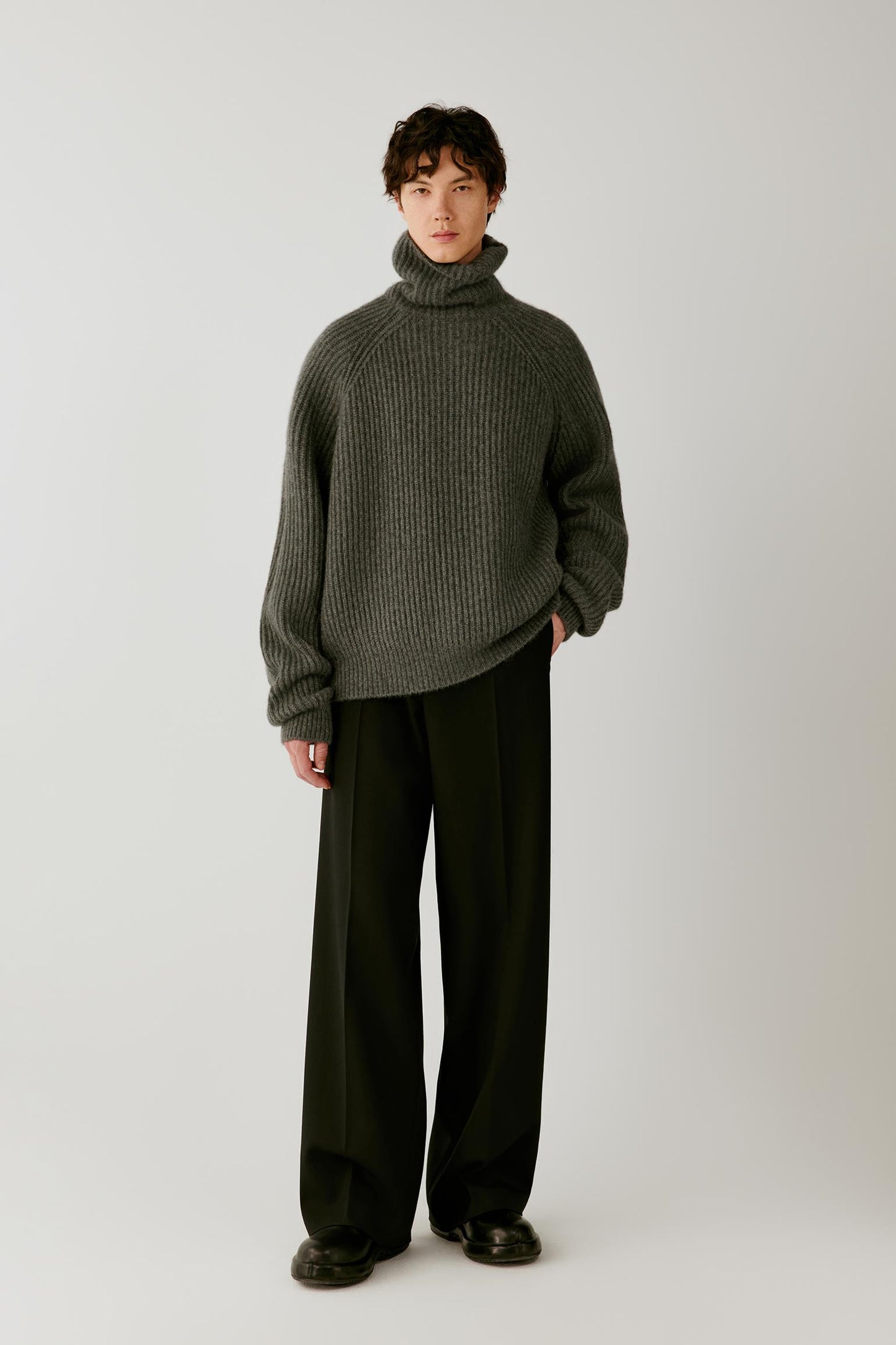 Full-length front view showing the oversized pullover, dropped shoulders and wide ribbed trims.