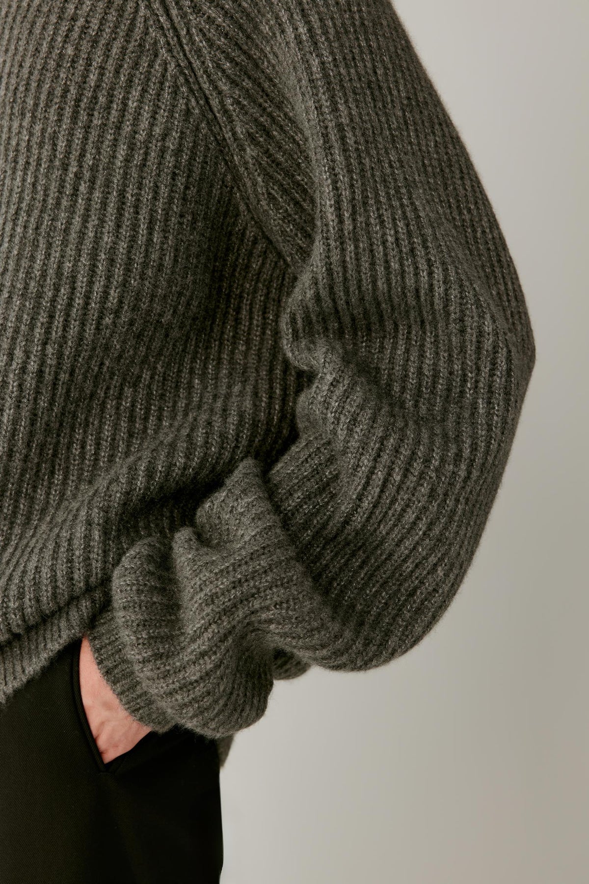 Close-up of the sleeve and cuff, highlighting the substantial ribbed knit and wide ribbed finish.