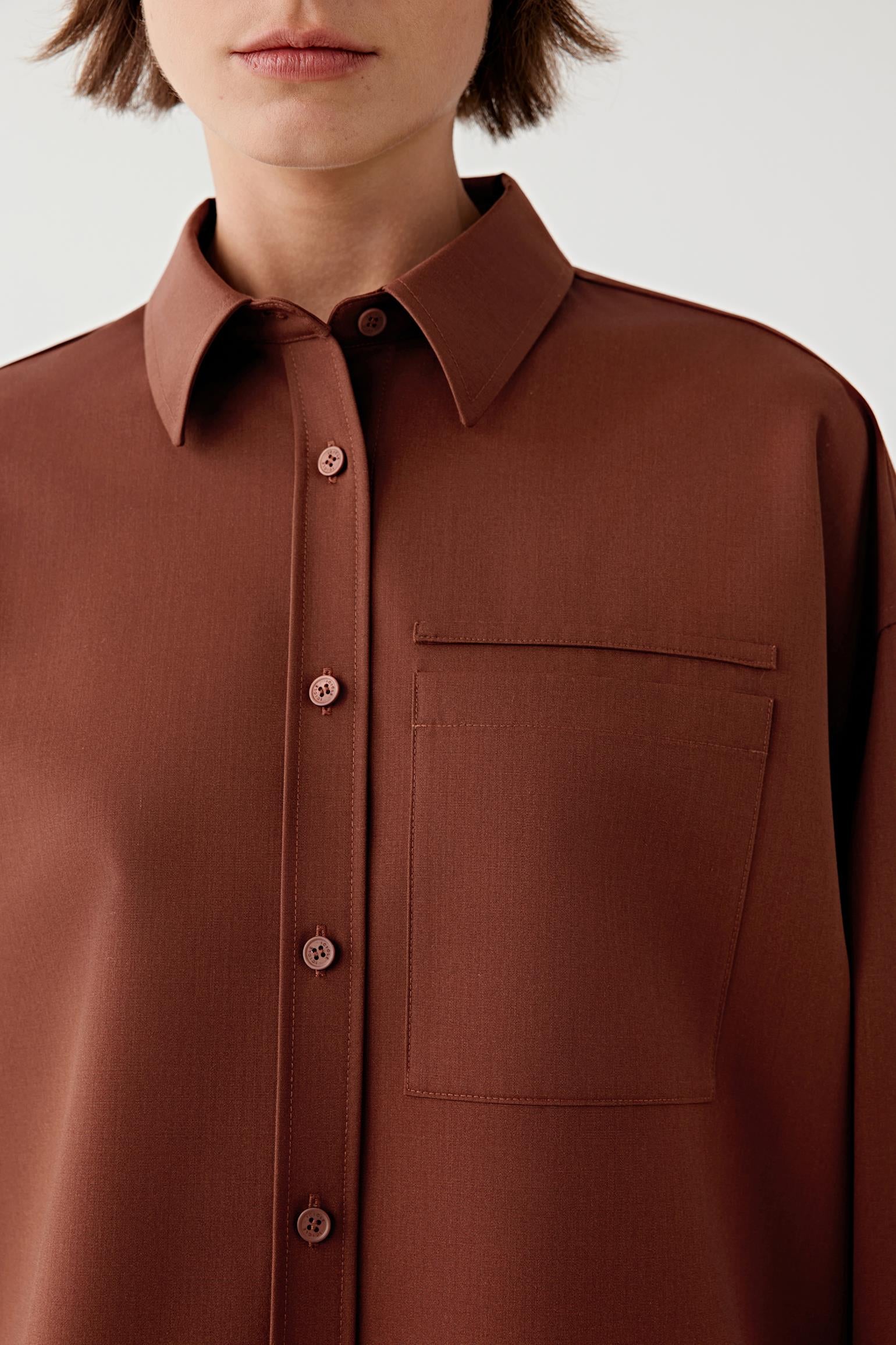 Brown shirt worn by a person on a white background