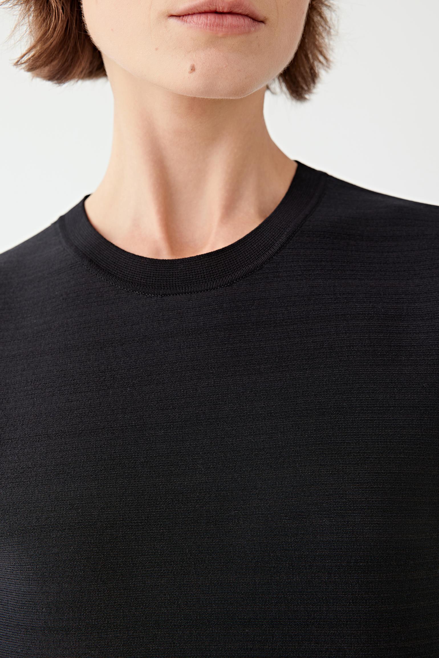 Black top worn by a person on a white background