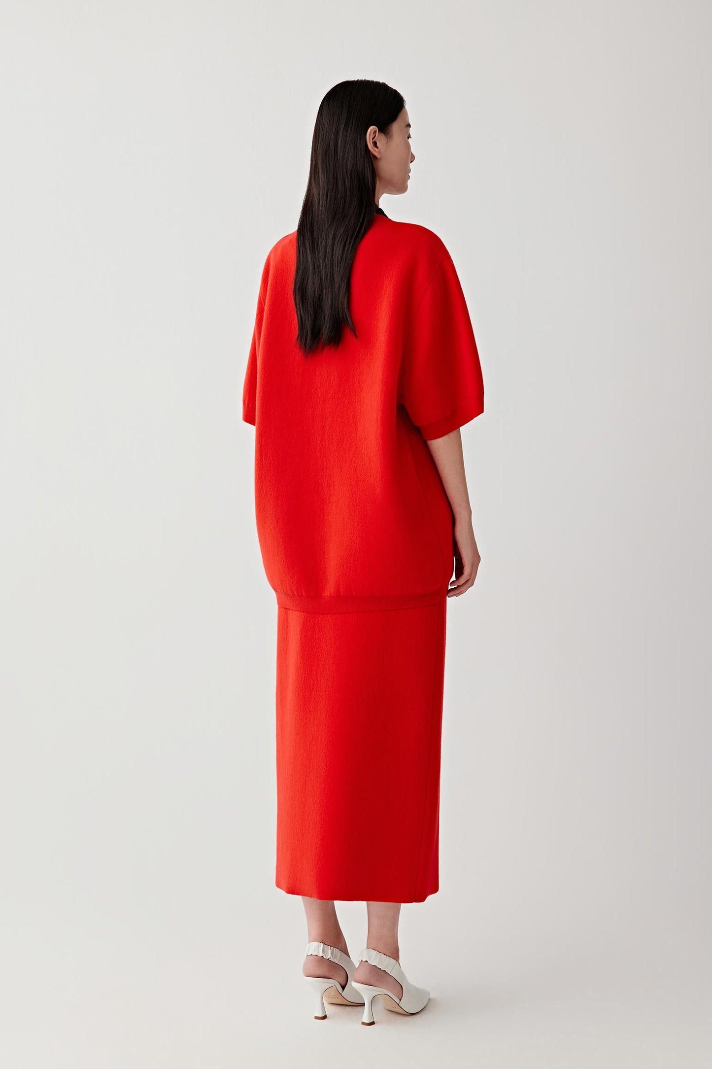 Woman wearing a red outfit on a white background