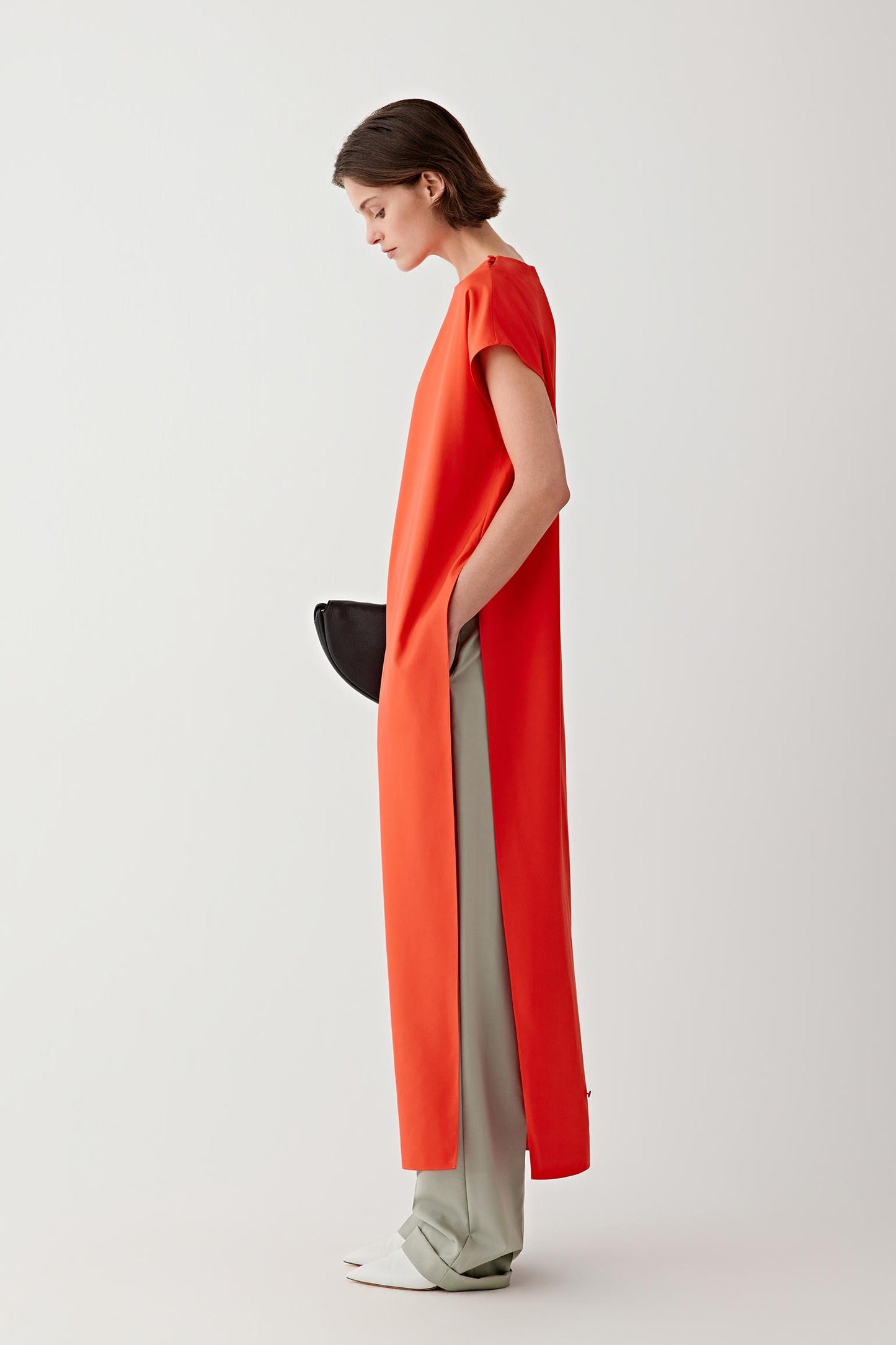Close-up of the side slit and fabric drape, highlighting the fluid construction, soft hand and lightweight structure of the silk fabric.