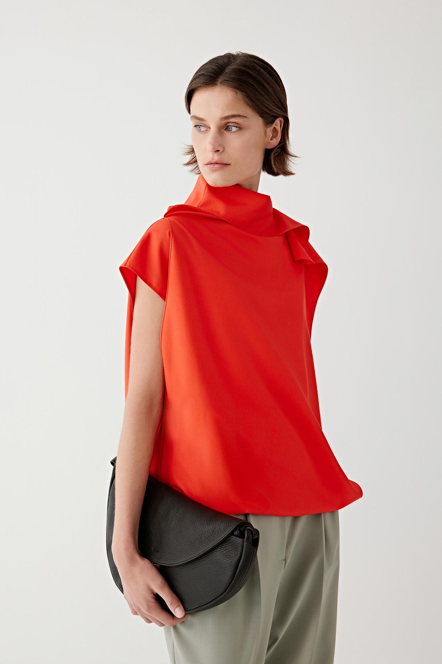 Side or three-quarter view highlighting the tied shoulder detail and soft construction through the body
