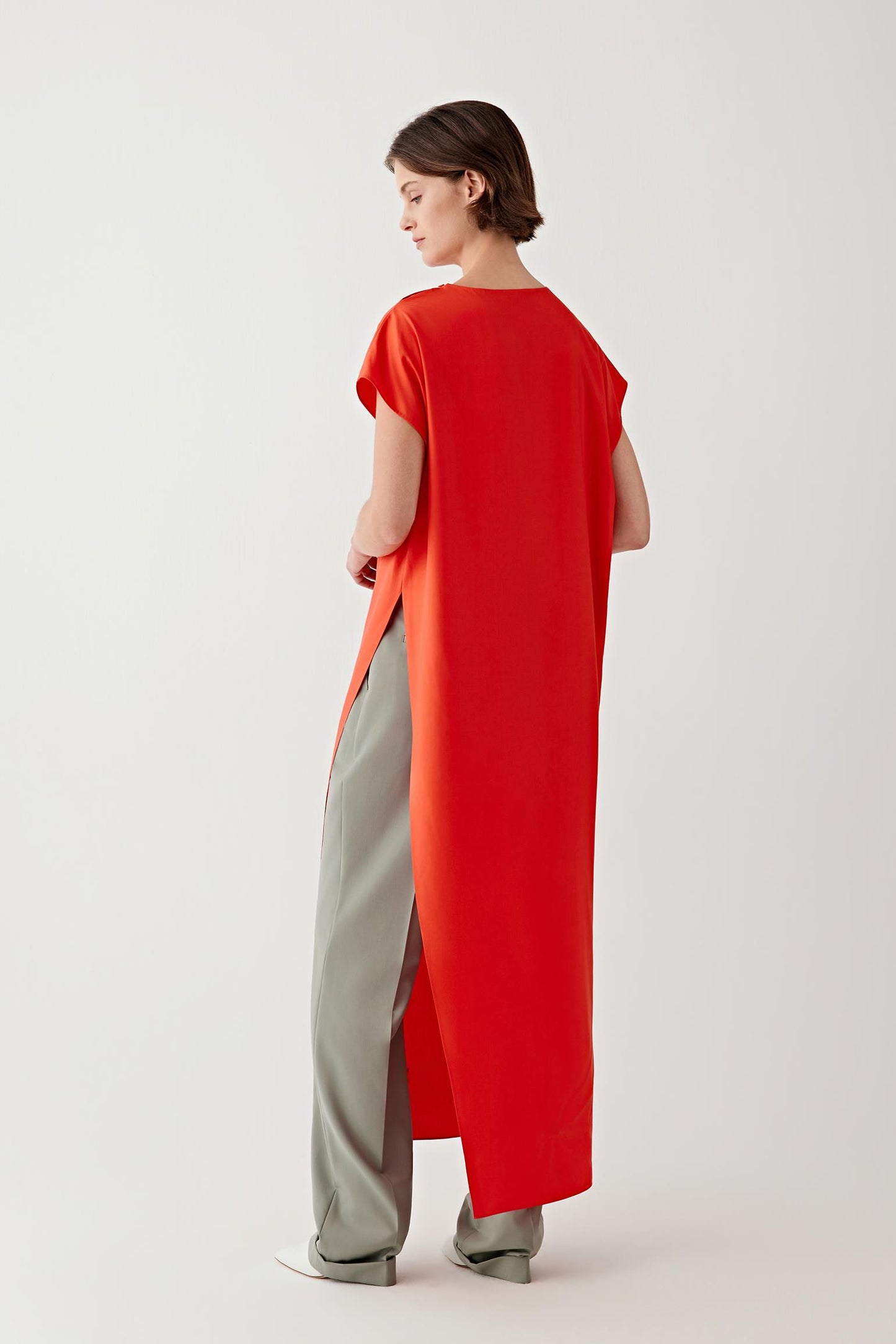 Close-up of the side slit and fabric drape, highlighting the fluid construction, soft hand and lightweight structure of the silk fabric.