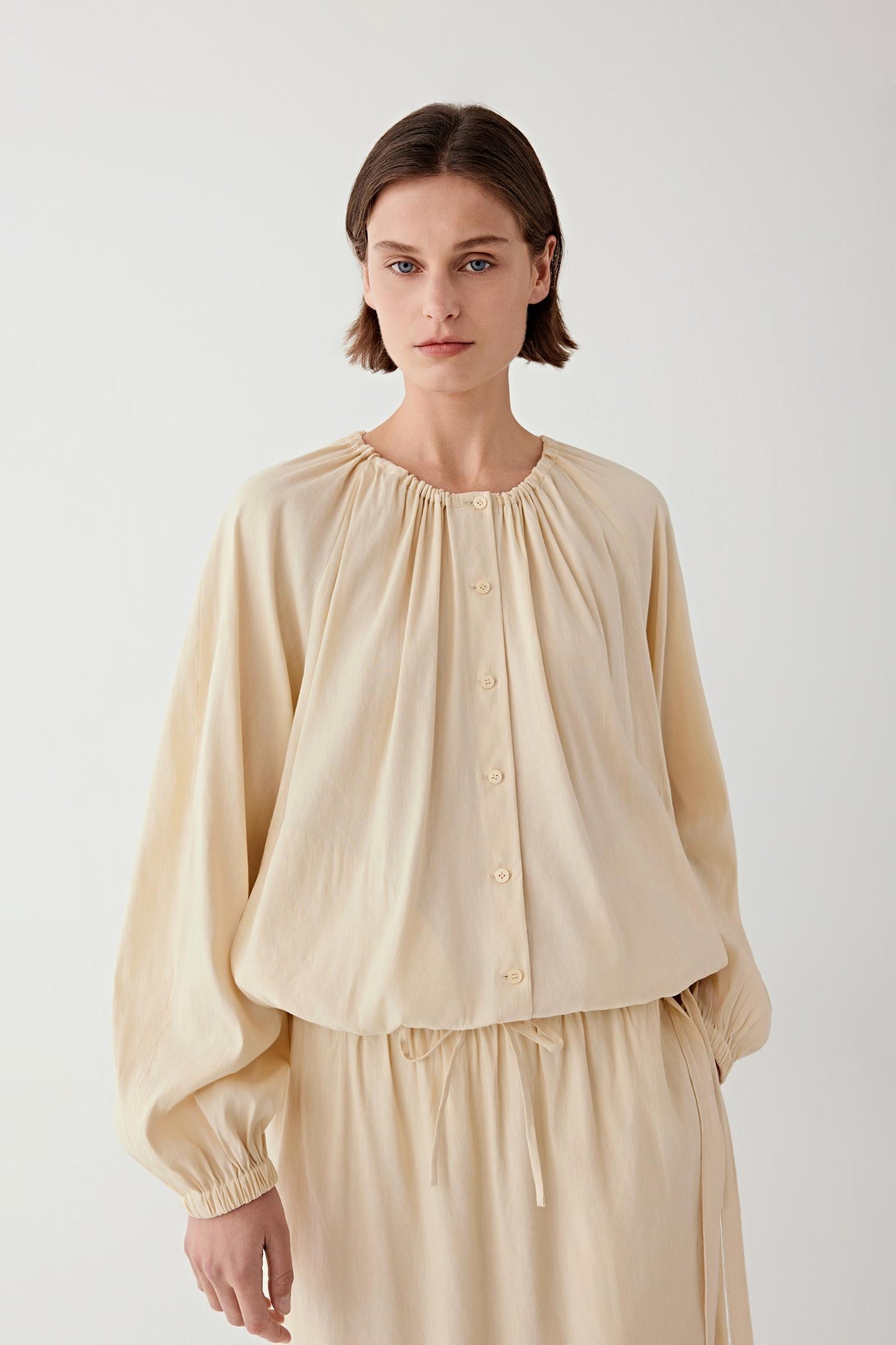 Front view showing the gathered neckline and soft volume.