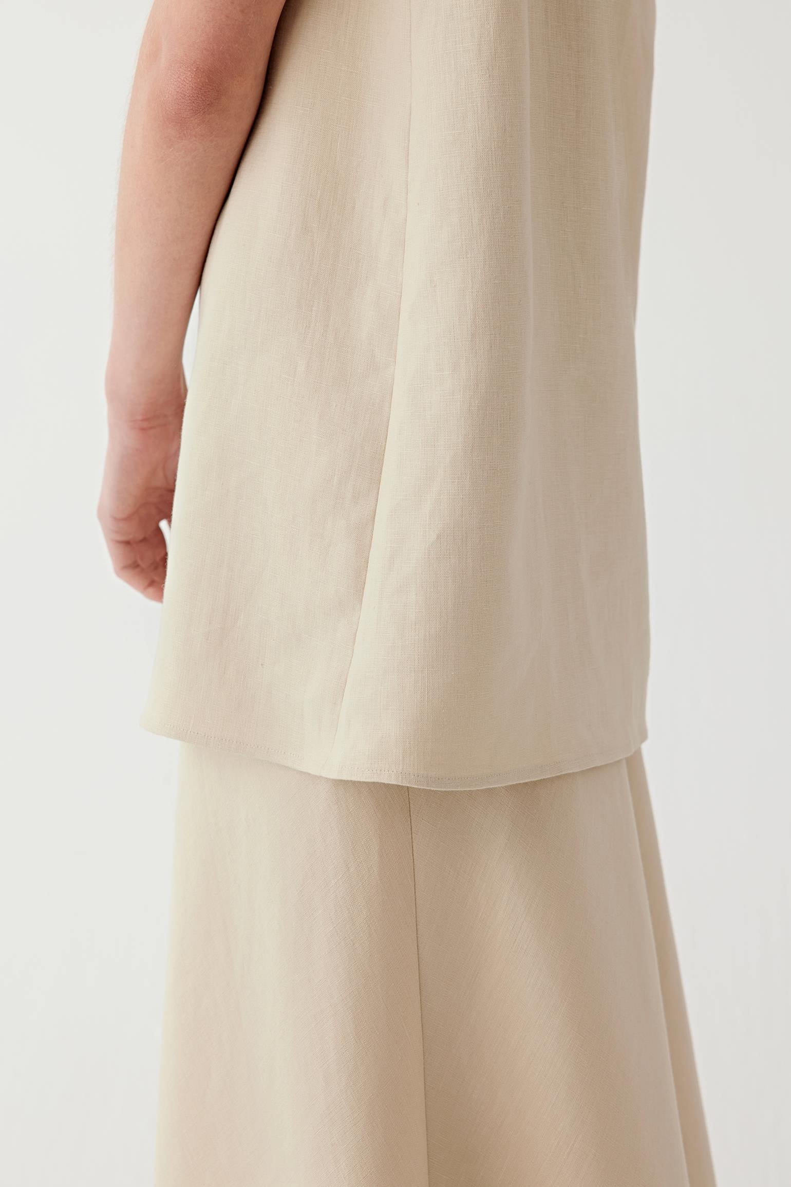 Close-up of the blouse hem and layered fabric detail.