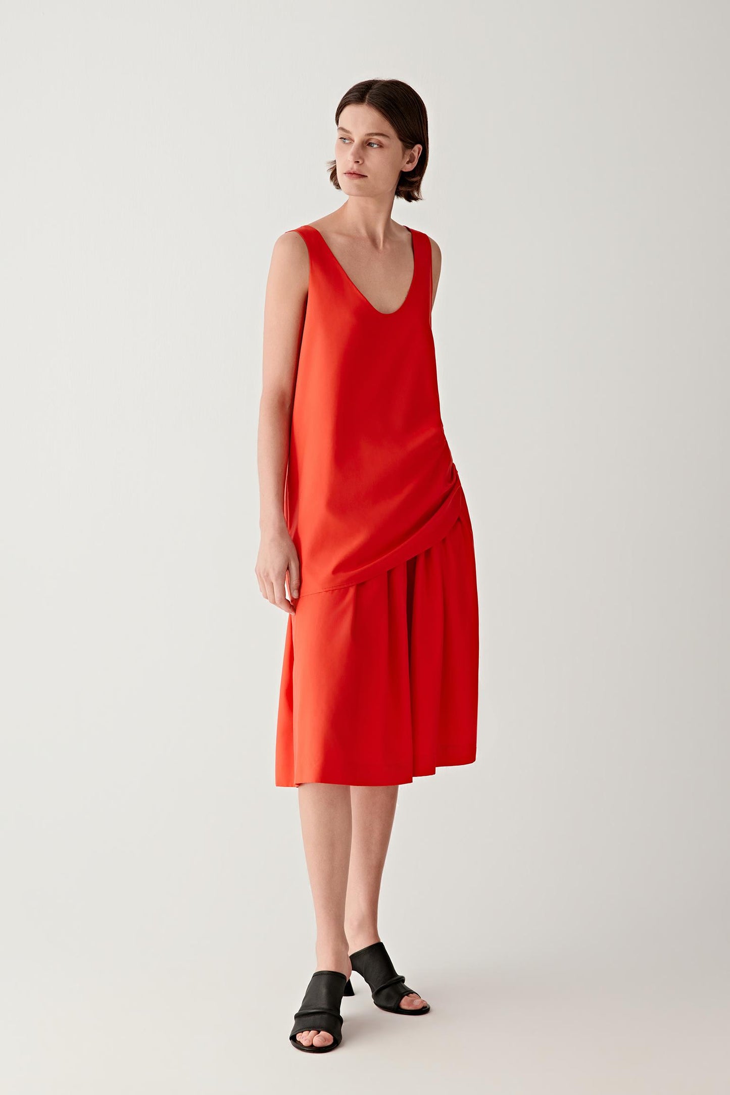 Full-length front view emphasizing the straight silhouette and scoop neckline, showing the soft movement of the silk poplin fabric