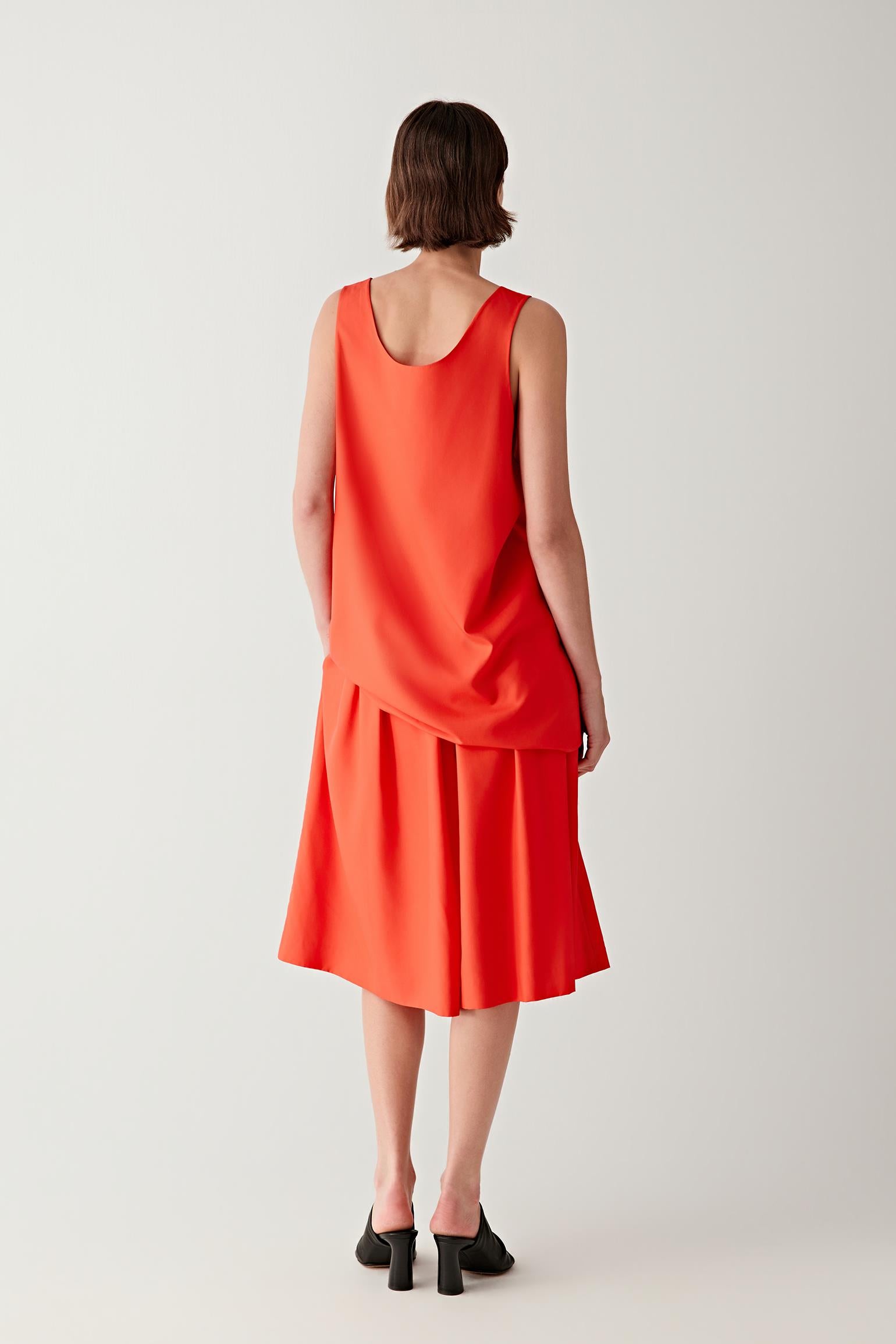 Side or back view highlighting the clean sleeveless cut and balanced straight line of the silhouette