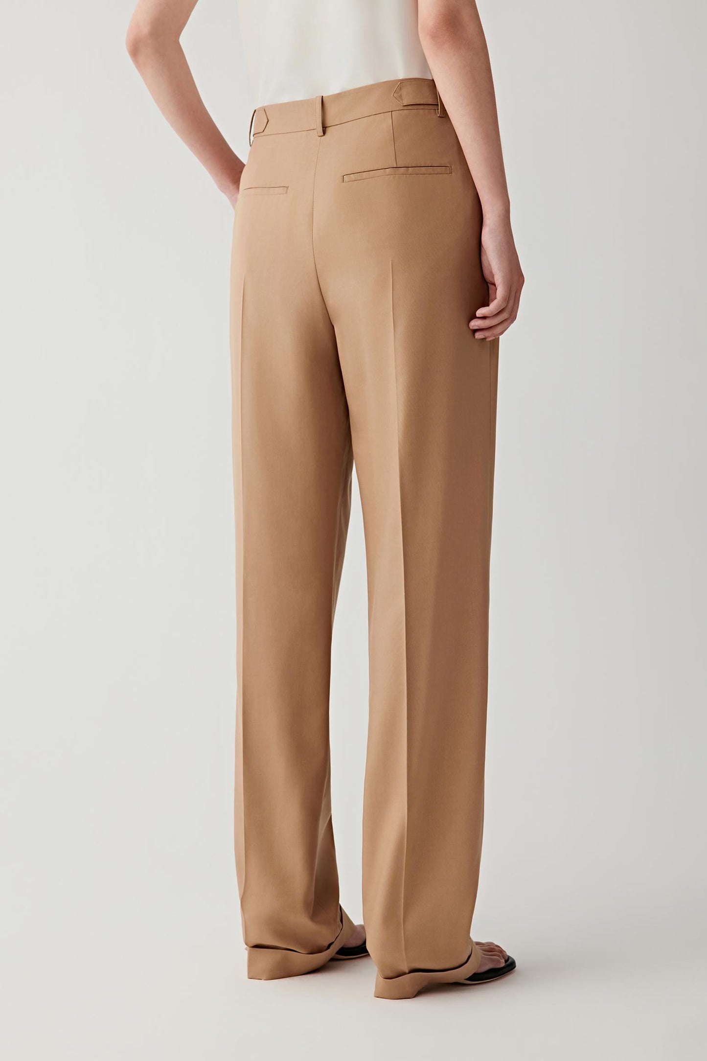 Mid-length side or back view highlighting the clean construction and fluid movement through the leg