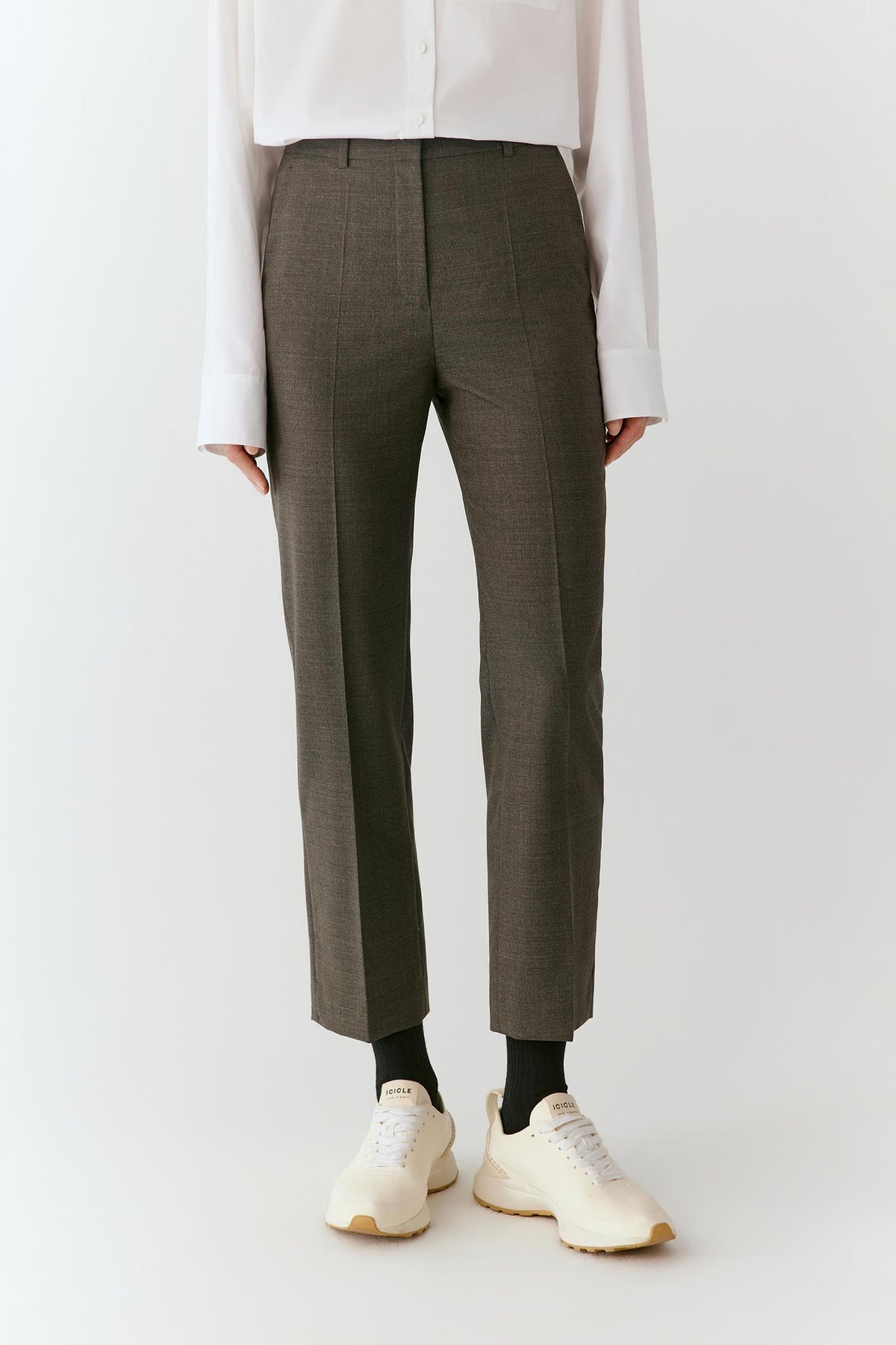 Full-length front view focused on the trousers, showing the bootcut shape, clean waistband and pressed front creases.