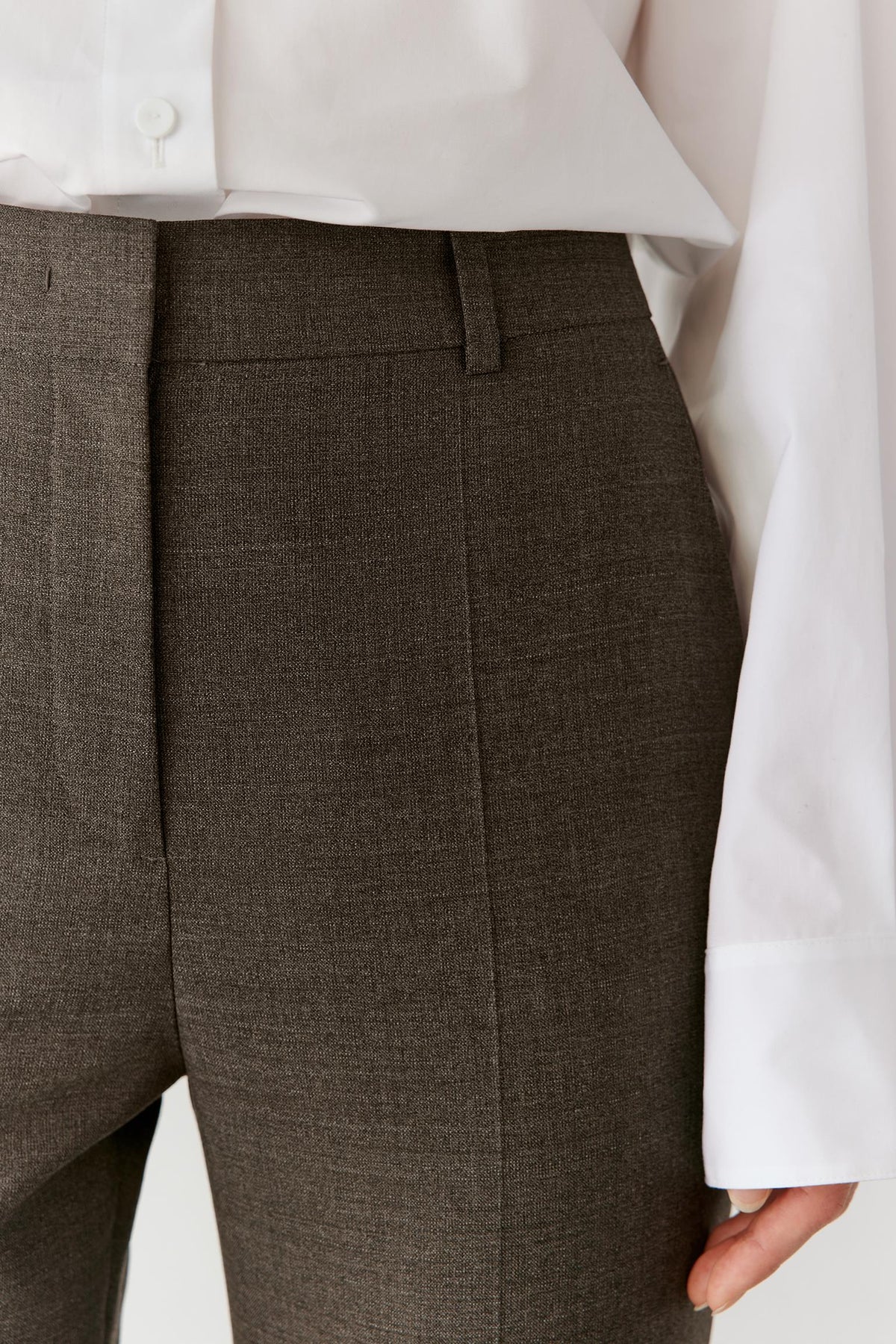 Close-up of the waistband and upper trousers, highlighting the clean construction and subtle melange texture.