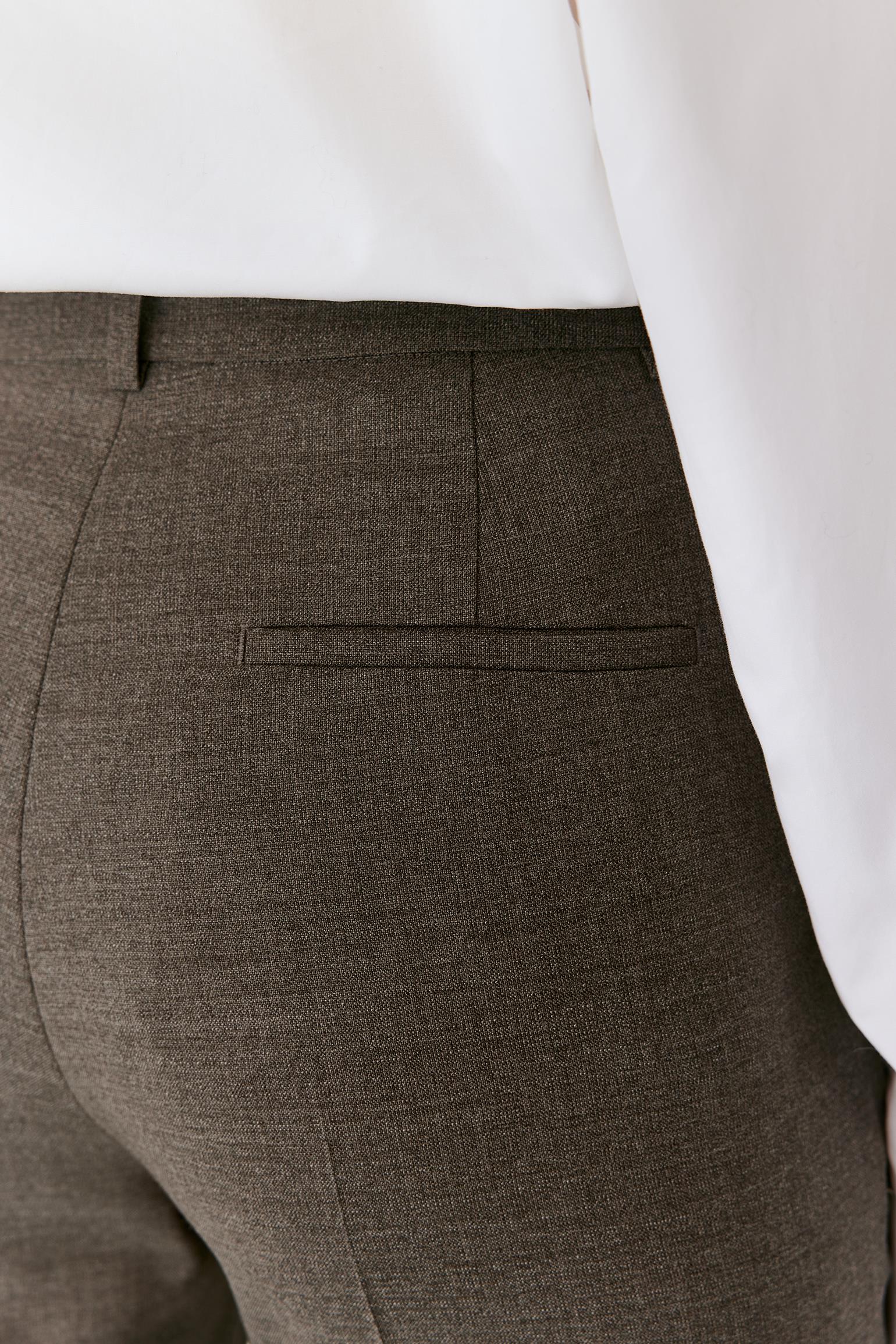 Close-up of the back waistband and welt pocket, showing the tailored construction and grey melange wool surface.