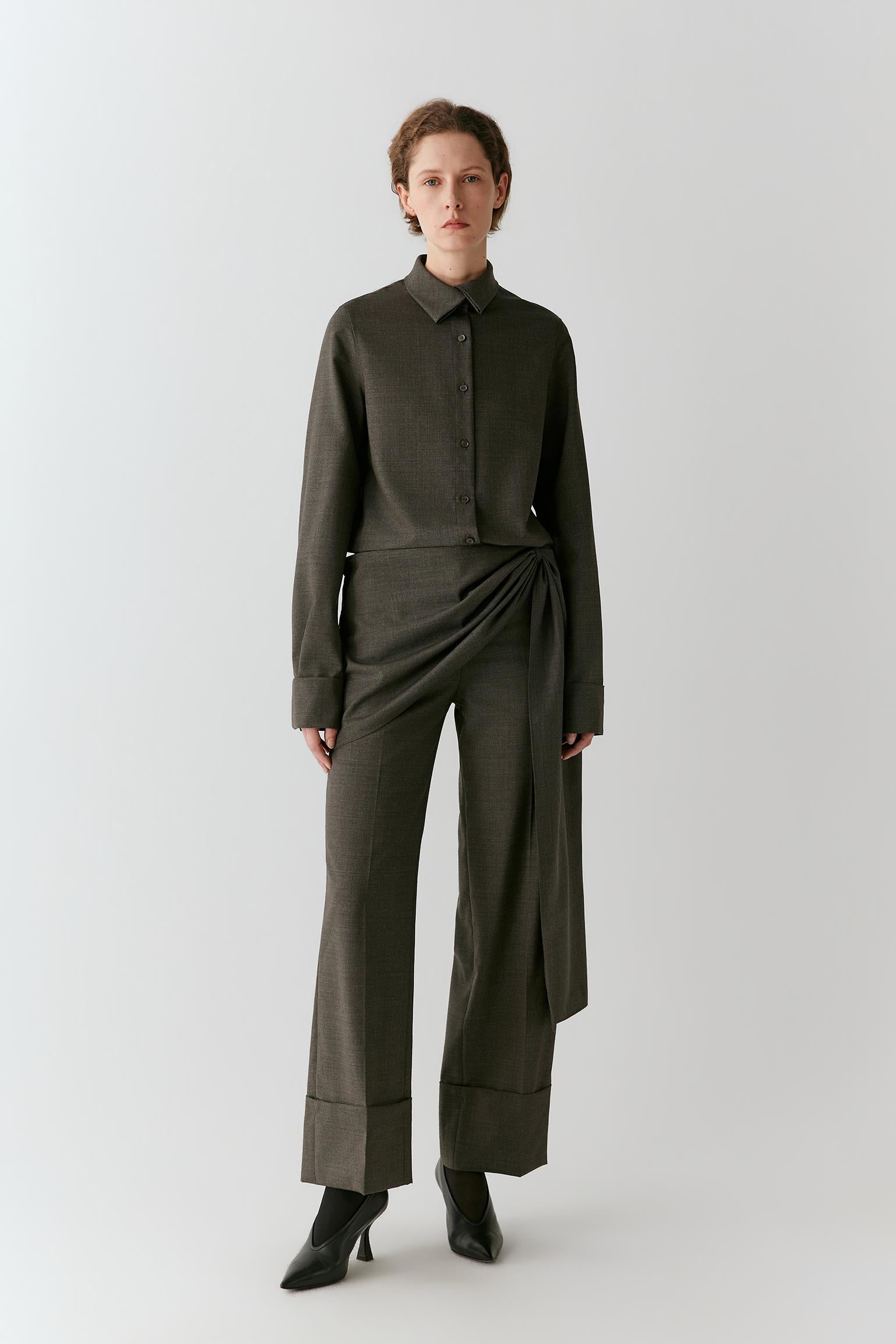 Full-length front view showing the shirt with matching trousers, emphasizing the elongated cut and clean lines.