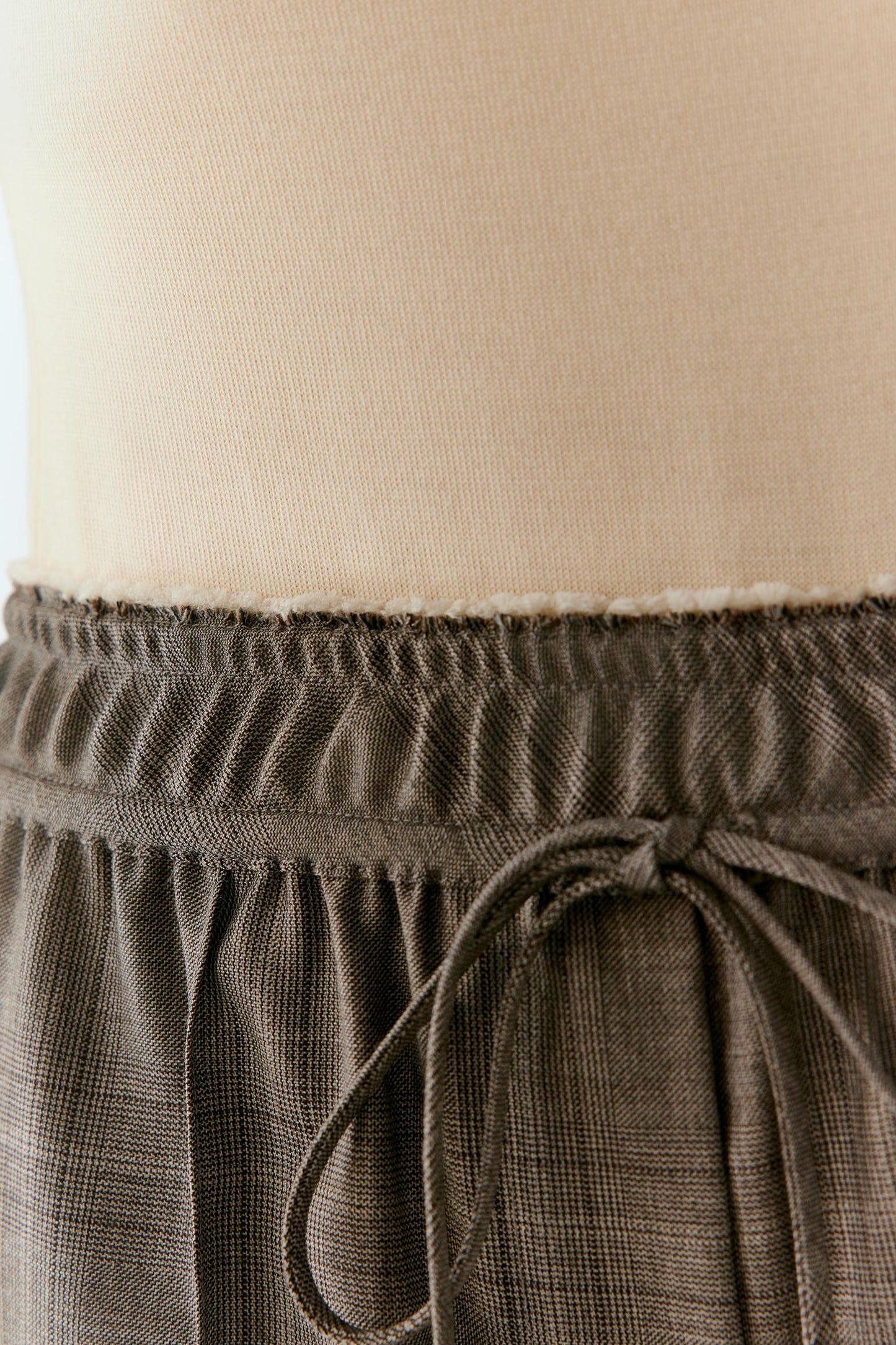 Close-up of the elasticated waistband and adjustable drawstring.