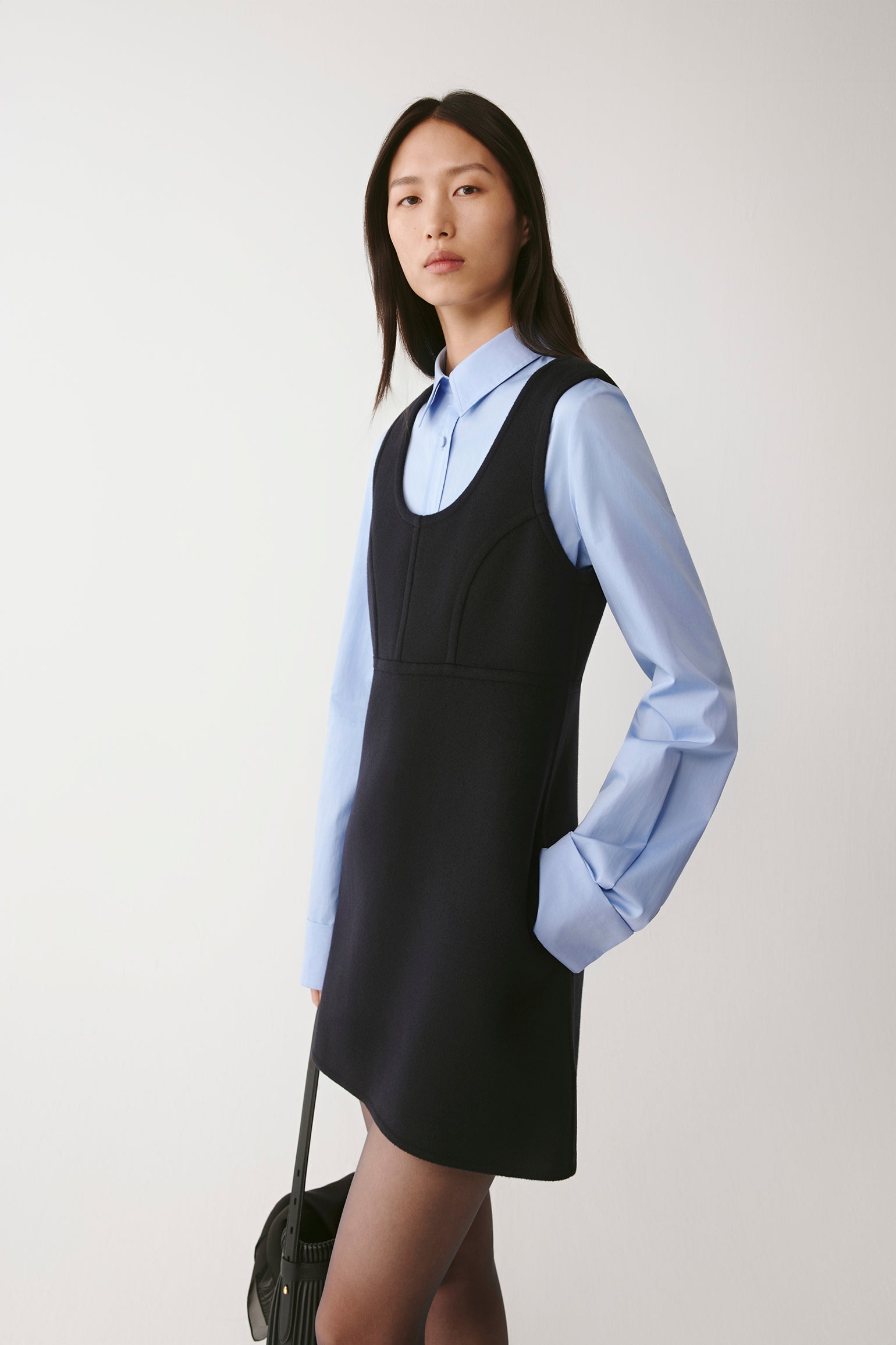 Three-quarter front view highlighting the clean lines and defined waist seam.