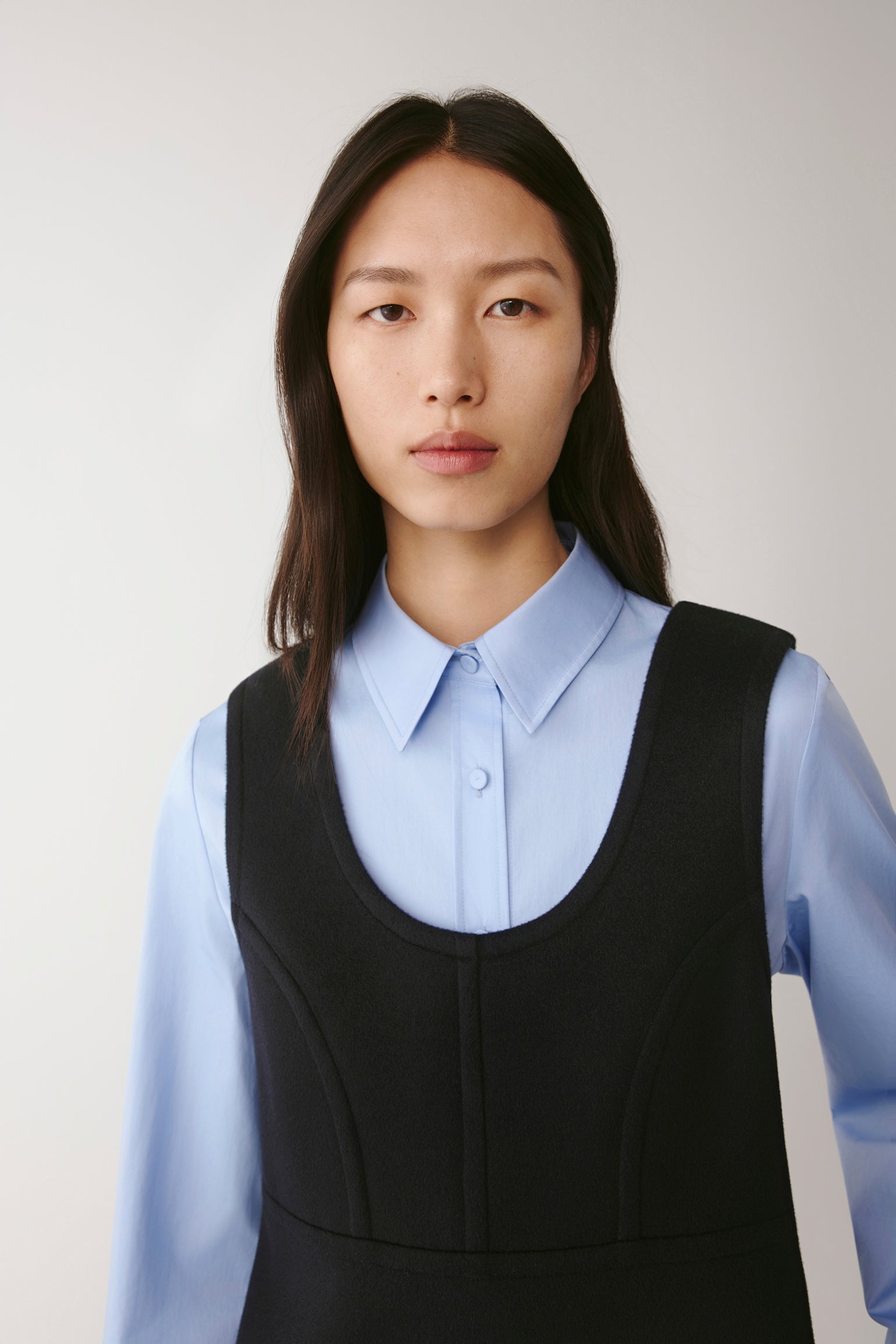 Portrait close-up of the neckline and bodice seams showing the contrast between fabrics.