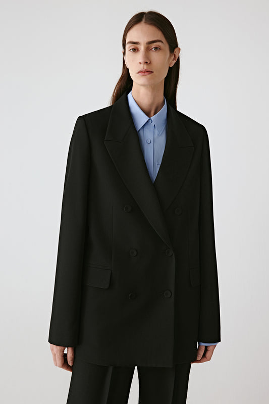 Three-quarter side view of the wool gabardine jacket, highlighting the structured shoulders and clean drape.