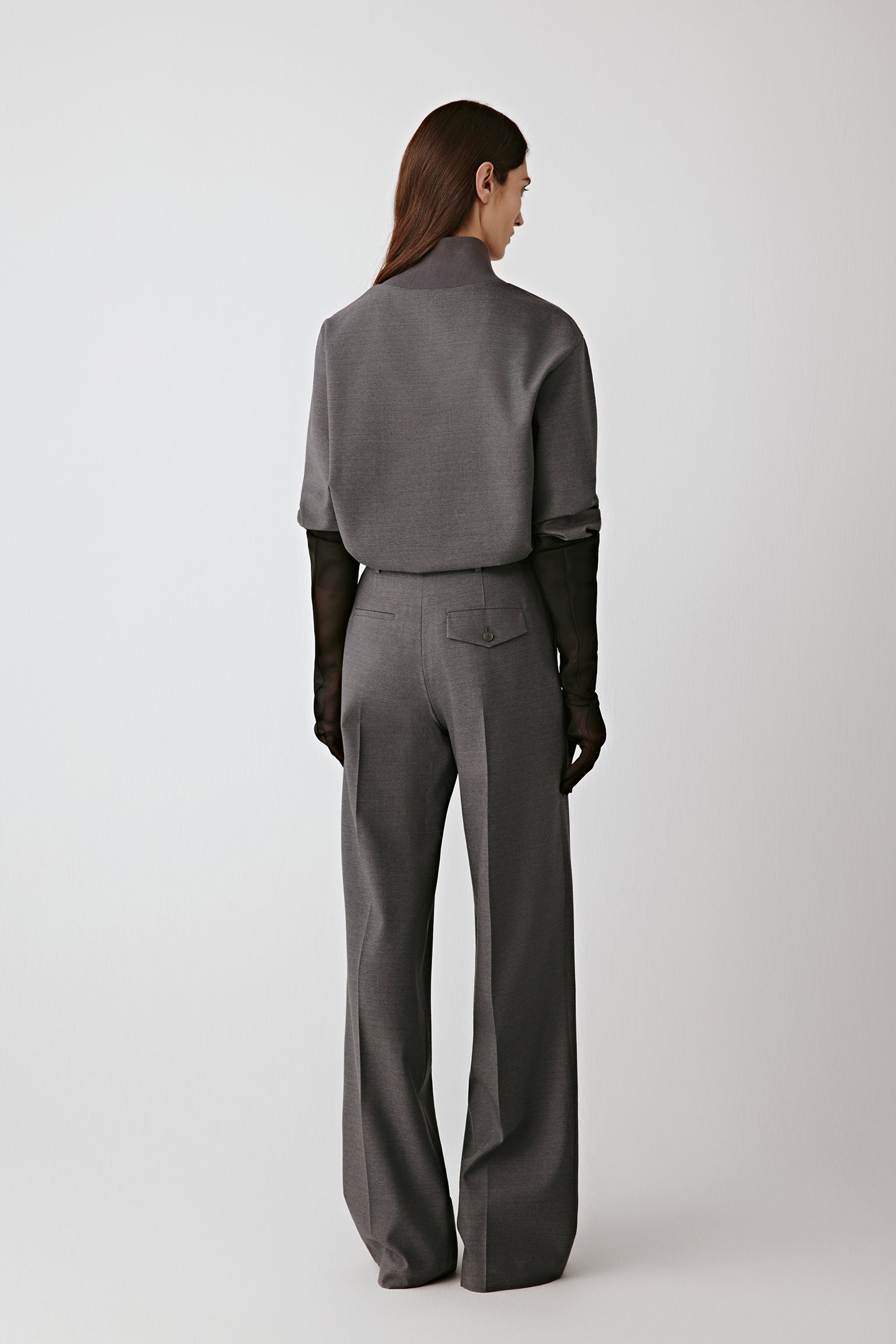 Back view of the wool sateen blouse, highlighting the clean seams and soft sheen.