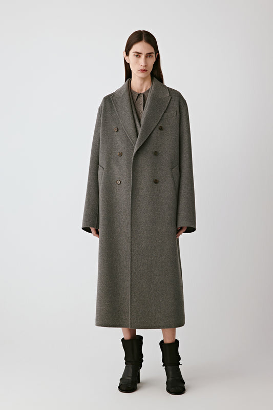 Front view of the long grey double-breasted wool and silk coat, showing its clean lines and fluid drape.