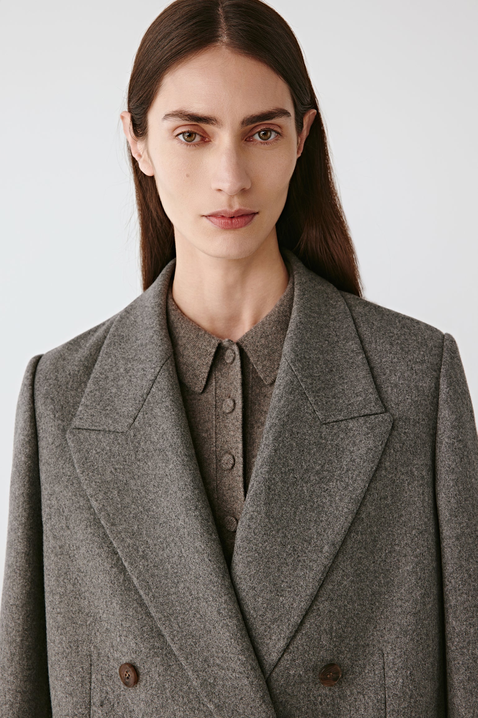 Portrait close-up of lapels and double-button fastening.