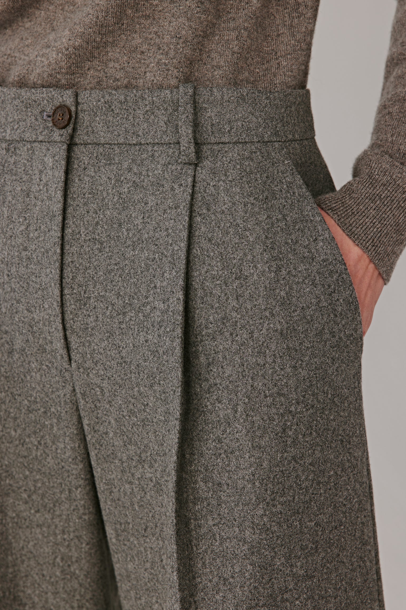 Back view displaying the smooth line and discreet welt pockets.