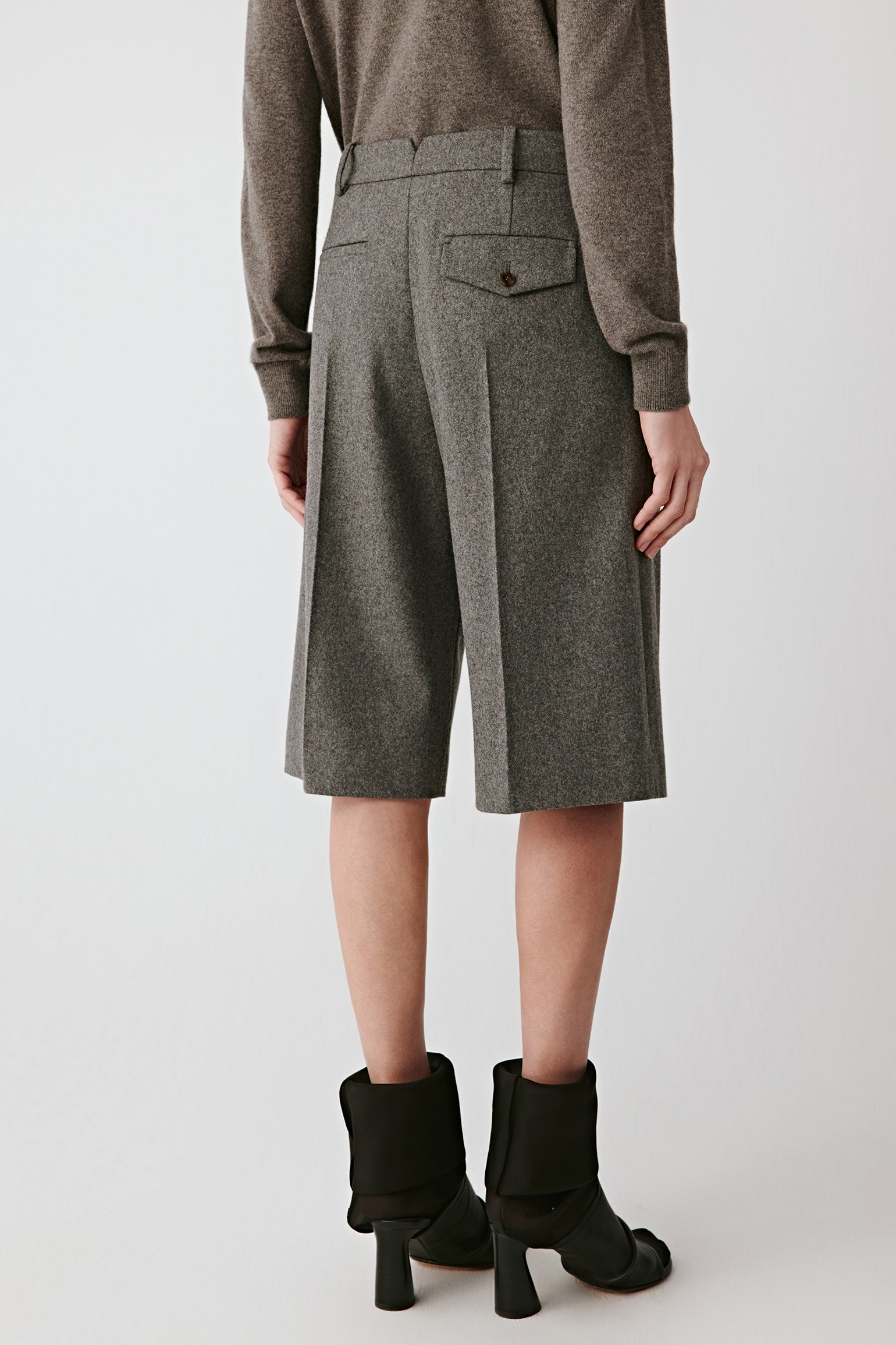 Side view showing the mid-length cut and tailored finish.