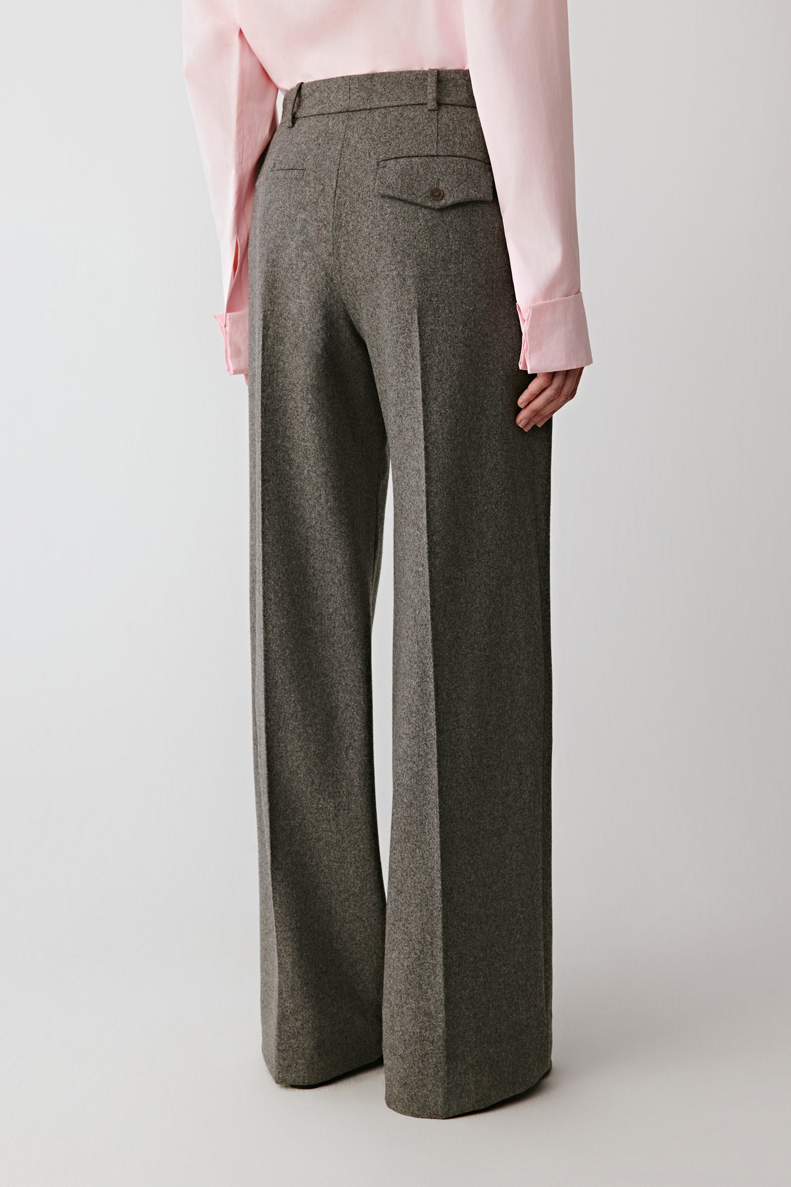 Back view of the trousers, highlighting the flowing lines and natural fabric movement.