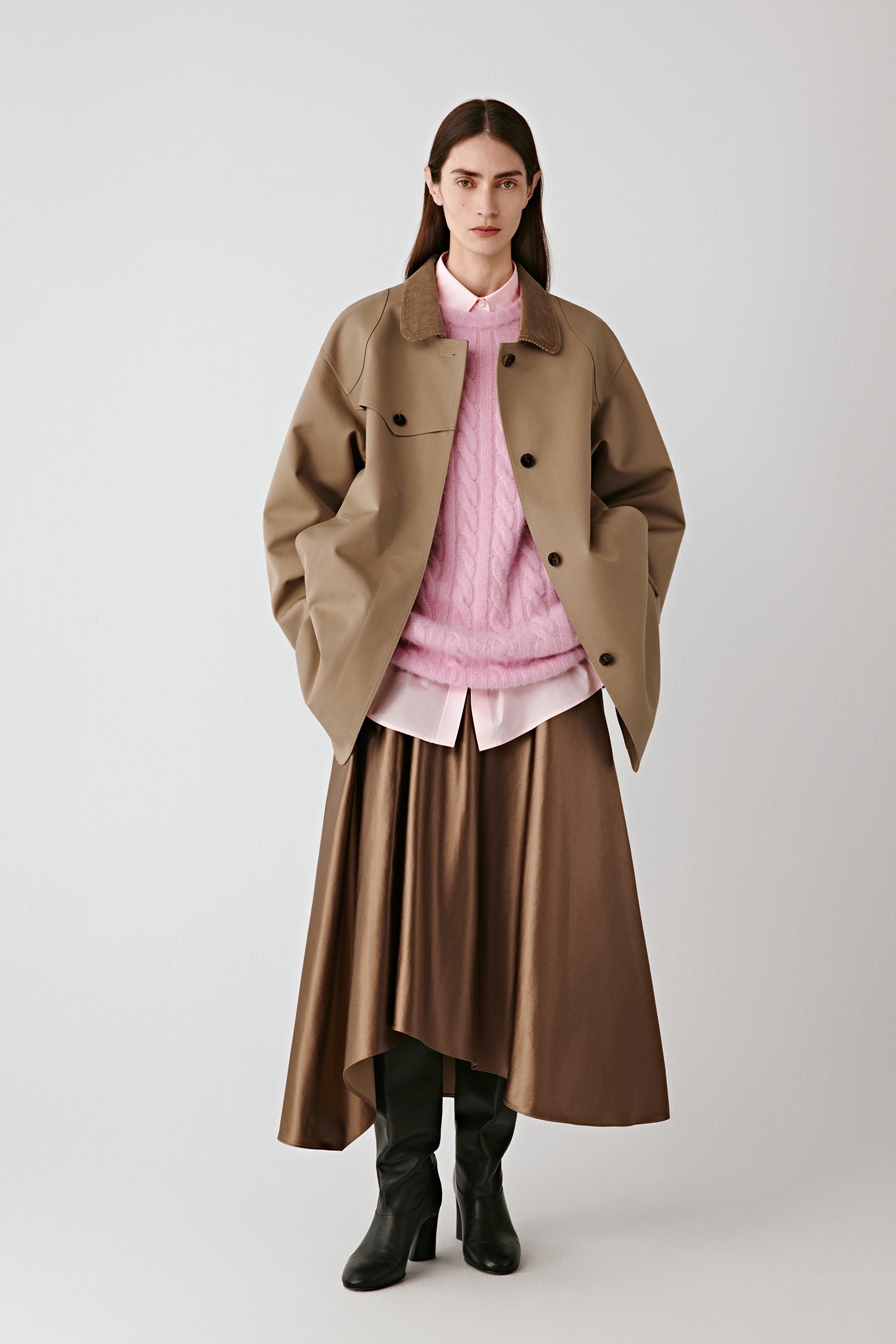Full-length front view of the model wearing the camel cotton and silk satin skirt paired with a soft pink blouse.