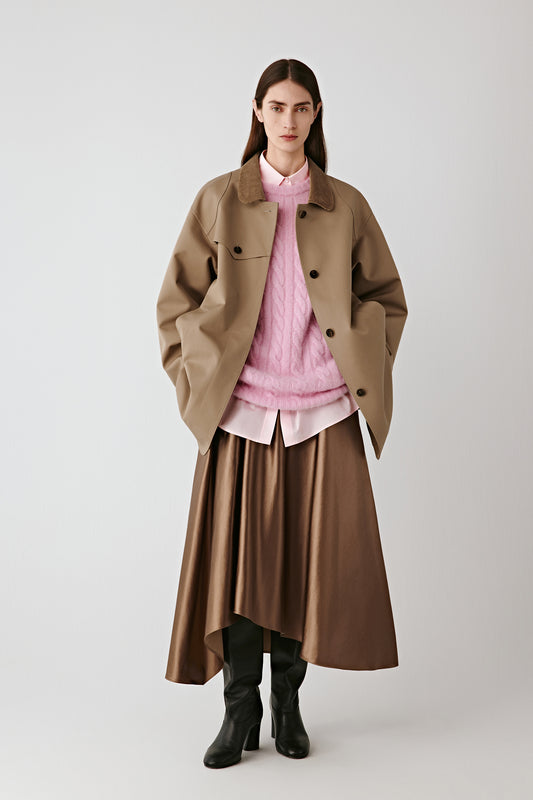 Full-length front view of the model wearing the camel cotton and silk satin skirt paired with a soft pink blouse.